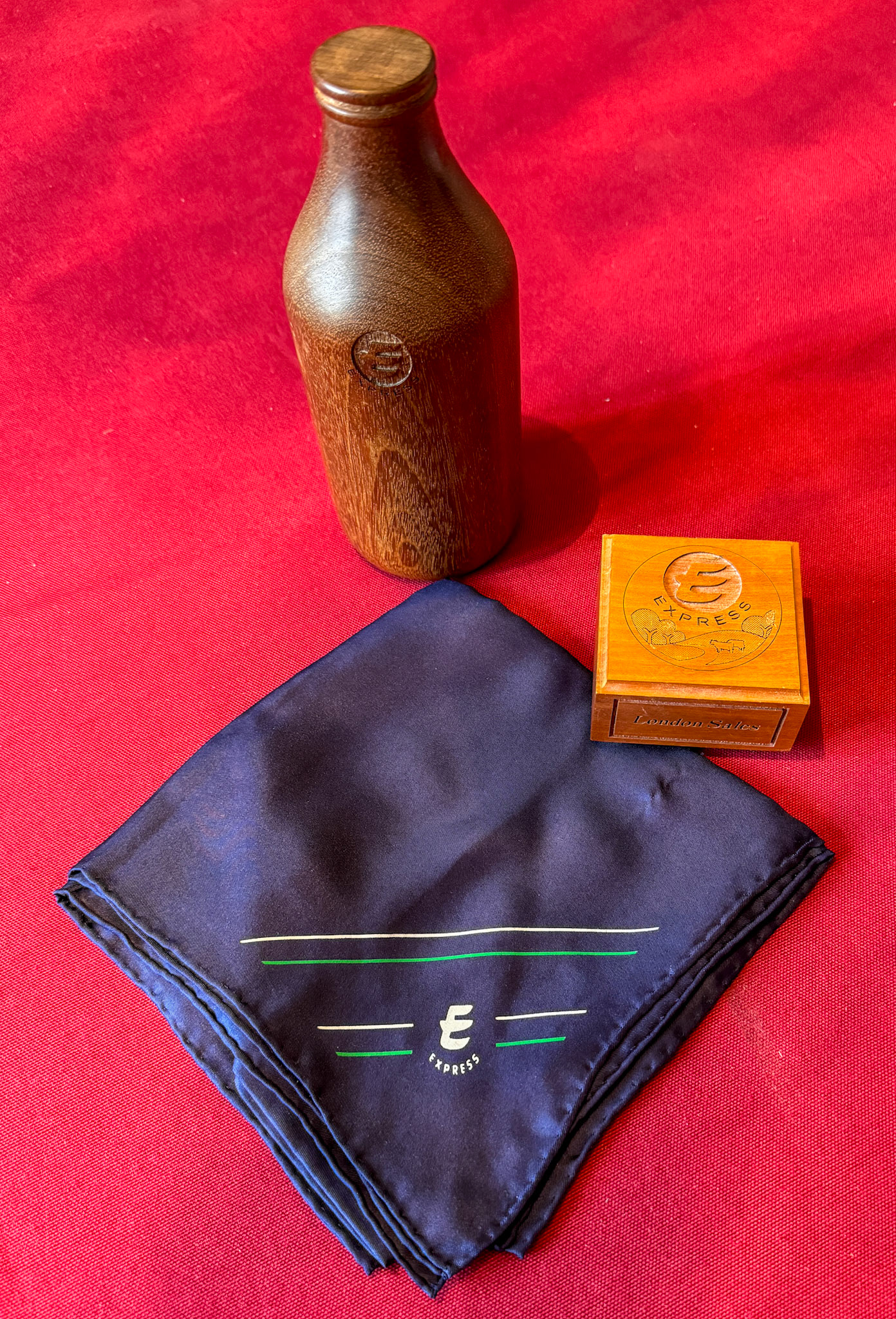 2024 Beryl Purslove memorabilia-wooden 'pintie' bottle, Express scarf and wooden paperweight.  (Courtesy Beryl Purslove)
