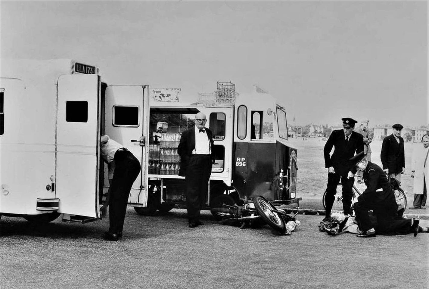 1960's Lloyd Rich comments "Blackheath, Goffers Road - accident between an Express Dairies Electruk Rider milk float and a motorcycle in the early 1960's. The motorcycle rider about to be carried into the LCC Daimler DC27 ambulance. The milk float does not appear to be damaged and will return to its depot about a mile away in Wemyss Road, Blackheath." (Courtesy Lloyd Rich)