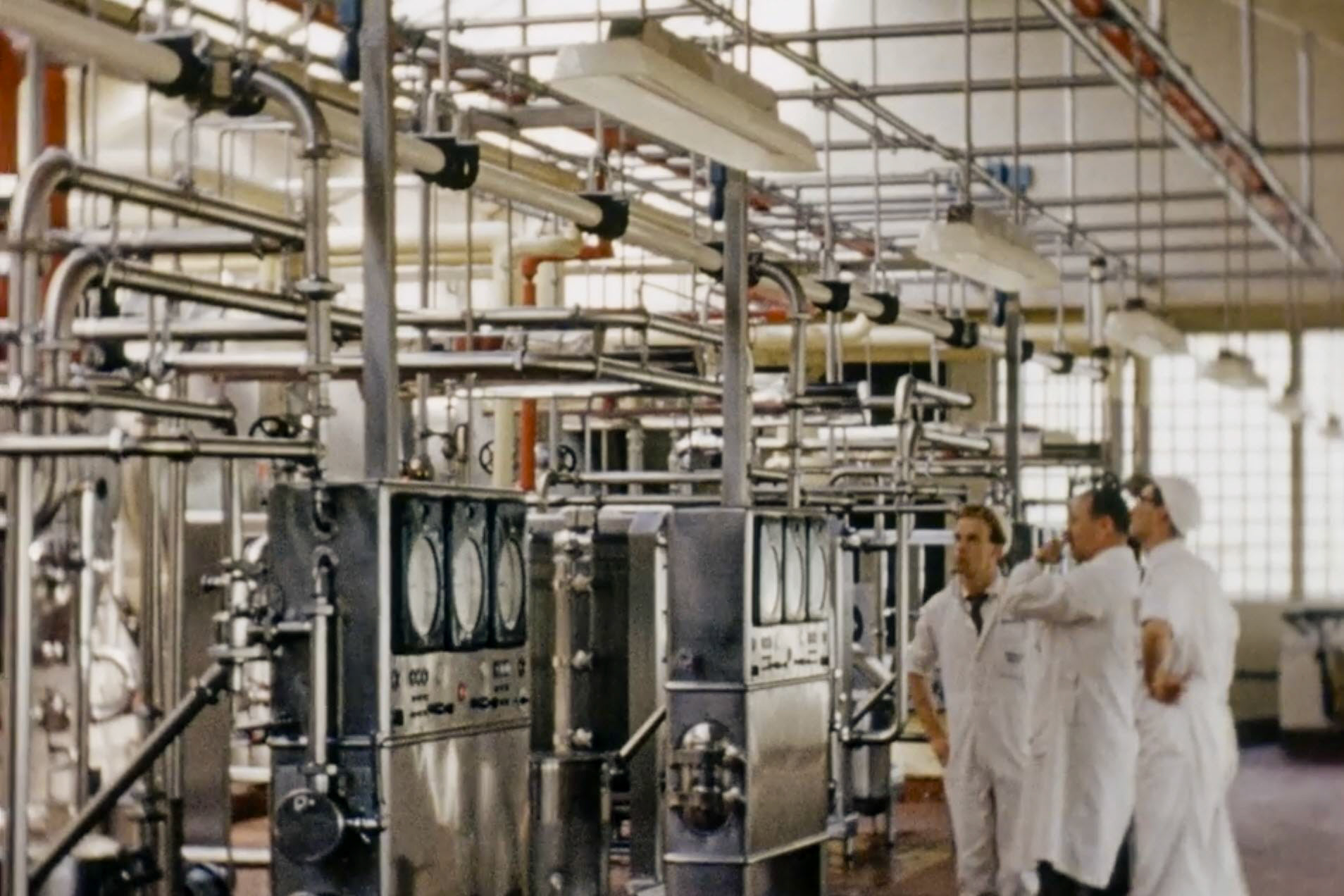 1954 South Morden Pasterising Floor. Possibly Mr McNair, Manager in the centre? (Stills from Express Dairy Film)