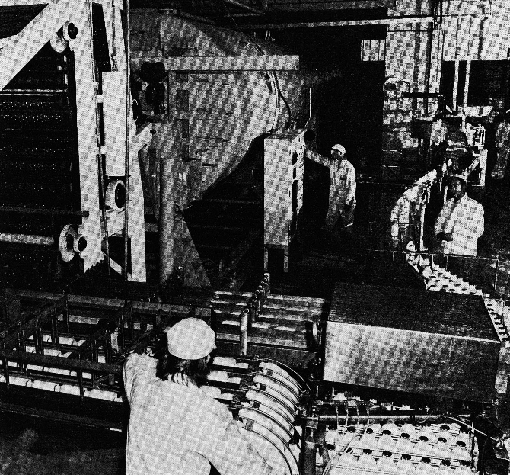 1976 The Hydrolock installation, where three people supervise a continuous process. Facing the camera: dairy foreman Stanley Leese (right) and recently married chargehand Philip Hindson. (Express News Christmas)