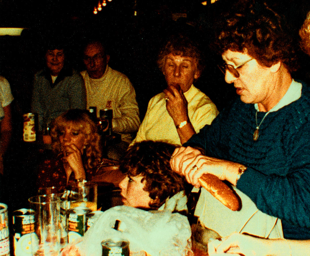 1983 November - Milk Division trip to Boulogne - Molly Bendon breaking bread in the bar. (Courtesy Beryl Purslove)