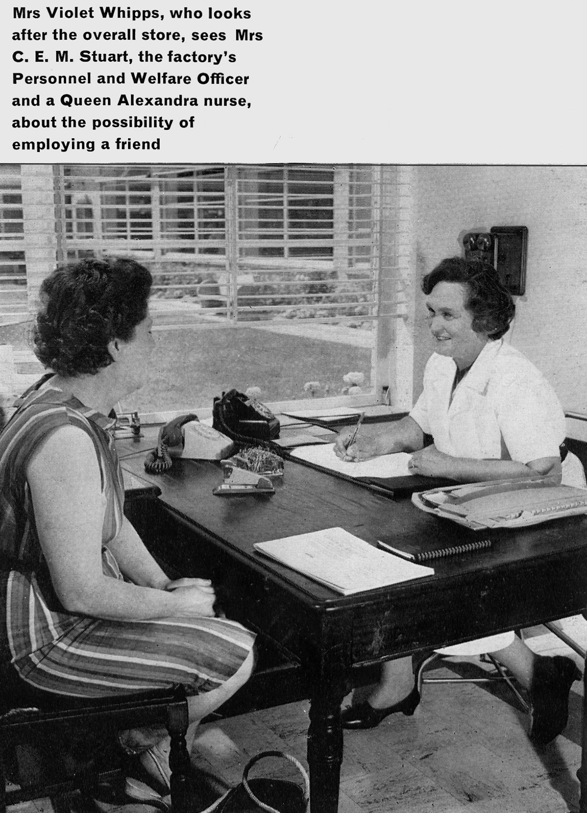 1963 Goldhanger Fruit Farm, Essex. Mrs Violet Whipps, in charge of the overall stores, talks to Mrs Stuart, Personnel and Welfare Officer. (Express News Autumn)