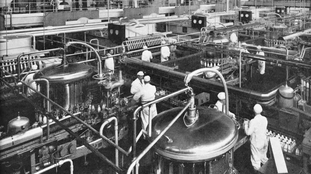 1950's Cricklewood Bottling Line.  Philip Boyd comments "There were 10 Alka fillers, replaced with 4 UDEC. There were also five bottle washers, replaced with two. This is how it was when I joined in 1957. You can see 10 temperature recorders and there were no recraters-these were developed later by engineer Mr Frank George. Cricklewood also had a second bottling hall with two fillers and one bottle washer, for bottling gold top (CI) milk." (Still from Steve Wheeler Milk Bottle Museum film)