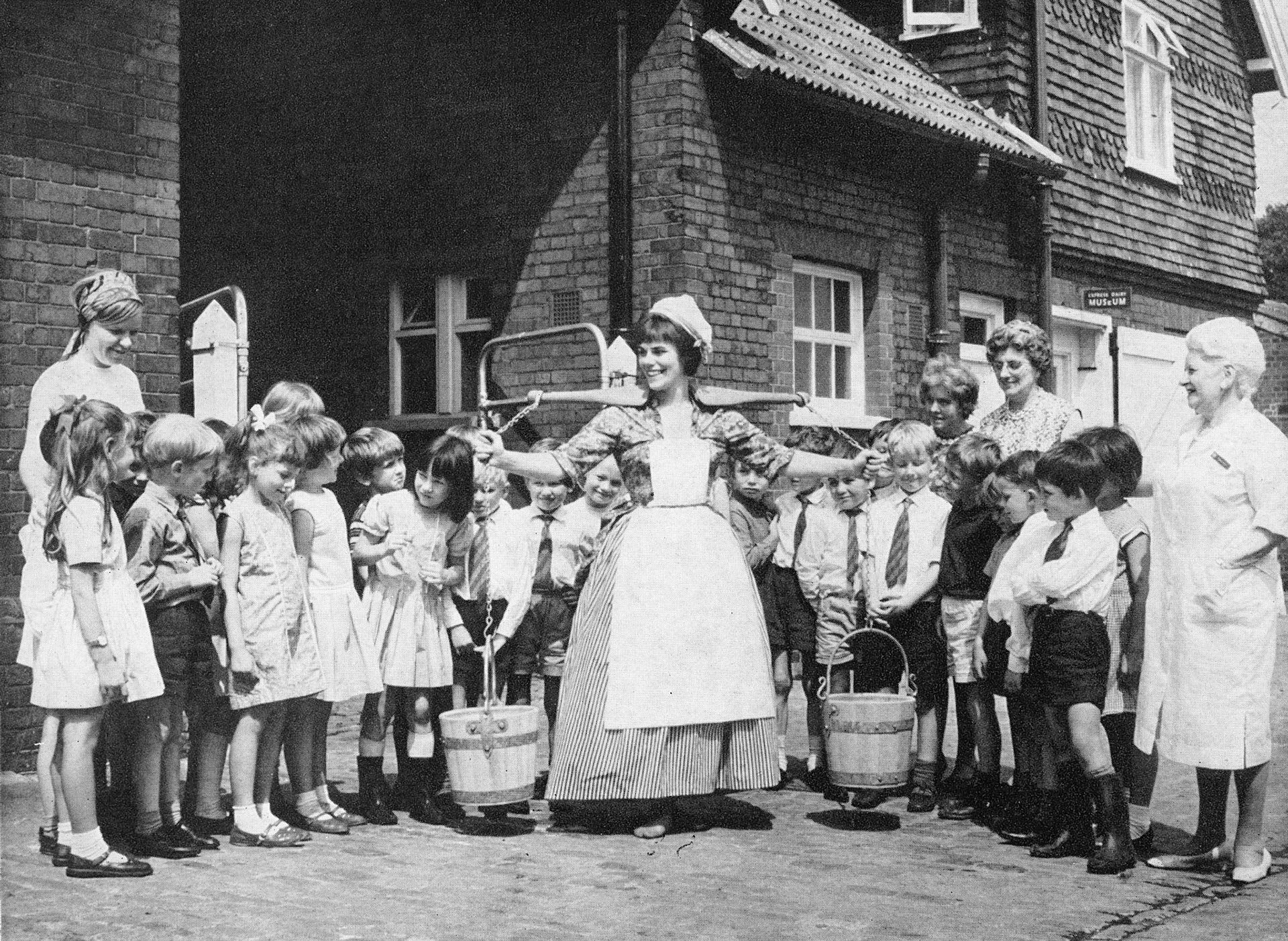 1967 Anne Malone, who usually demonstrates at College Farm, Finchley, with children from Whitehall Infants School in Uxbridge