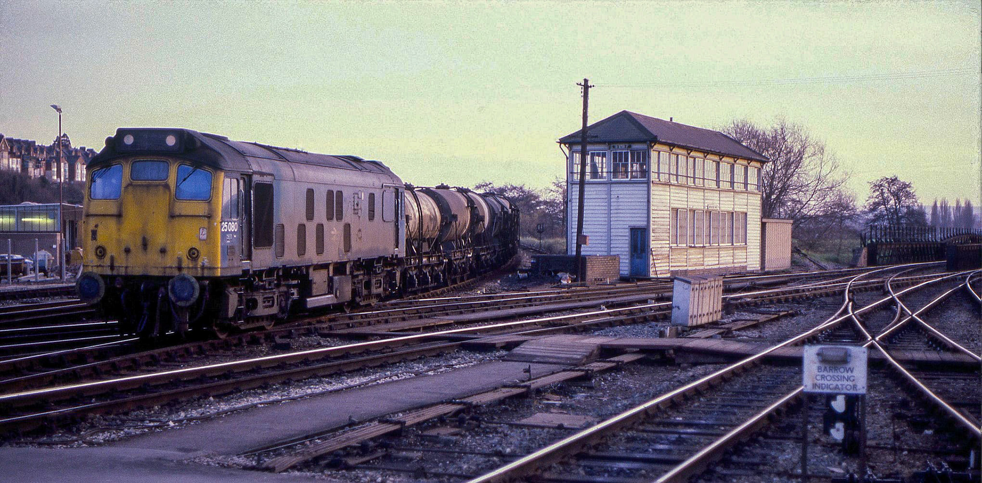 1970's? 25080 arriving at St. David's with the Chard Junction Milk Tanks. Frank Huddy comments in 2024 "Chard Junction milk factory was utterly obliterated about five years ago; nothing remains today, just returned to nature as a meadow beside the River Axe". Matthew Pinto comments "Up until the mid-60s, milk from Chard was worked up the SR mainline. When the lines west of Exeter were transferred to the Western Region, the milk was worked to Exeter and consolidated with tanks worked from further west. They were then worked up the former GWR line to London." (Courtesy Pete Doel)
