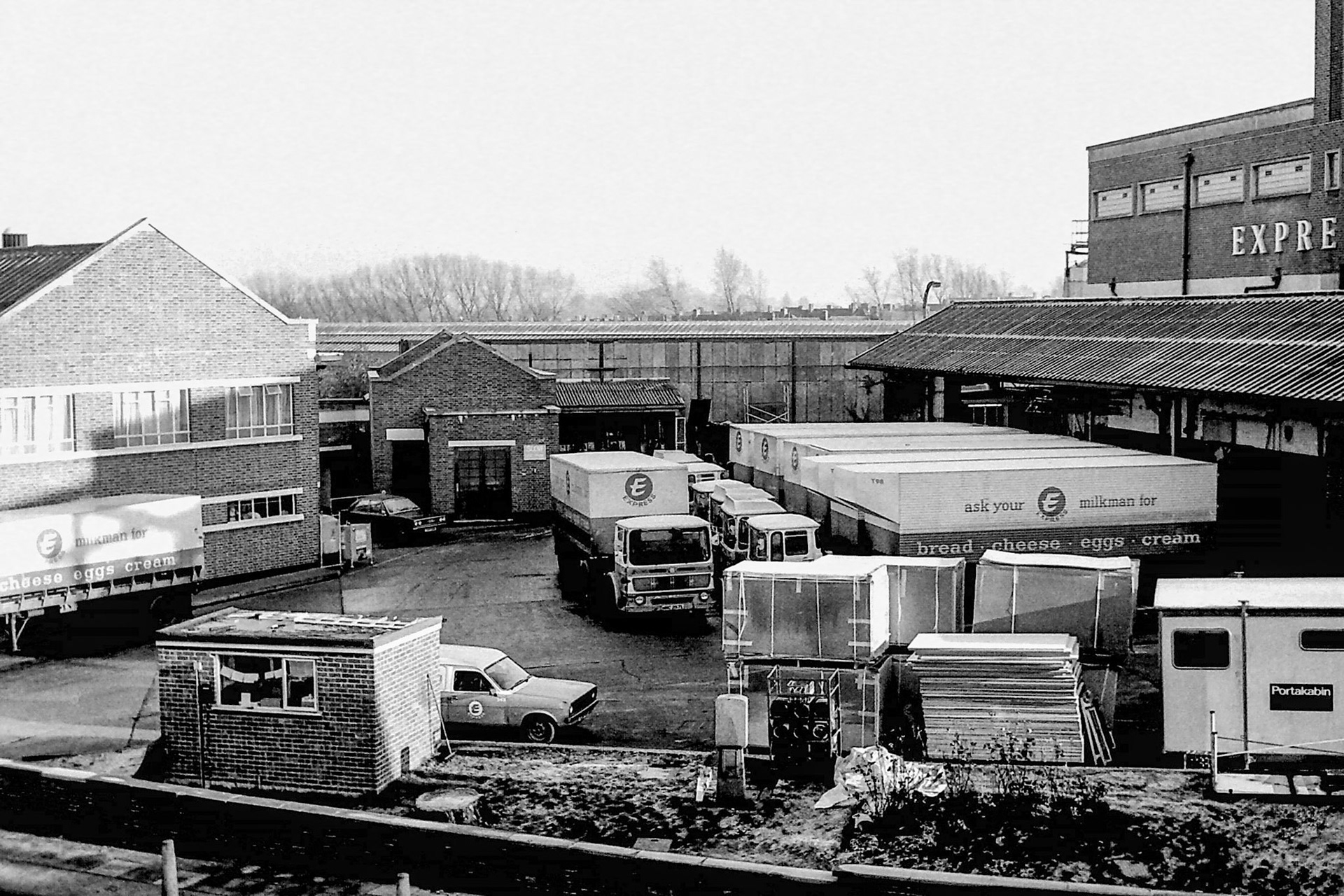 1979 Busy scene in the front yard at South Morden, with materials and contractor's hut temporarily located before the new cold store and loading bays were constructed. (Photographer Sam Jones)