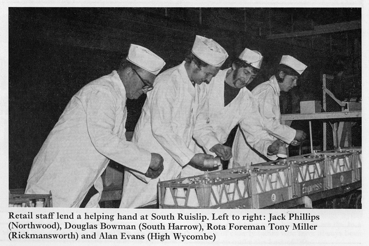 1972 Retail staff Jack Phillips (Northwood), Douglas Bowman (South Harrow), Tony Miller (Rickmansworth) and Alan Evans (High Wycombe) apply promotional bottle collars at South Ruislip Processing