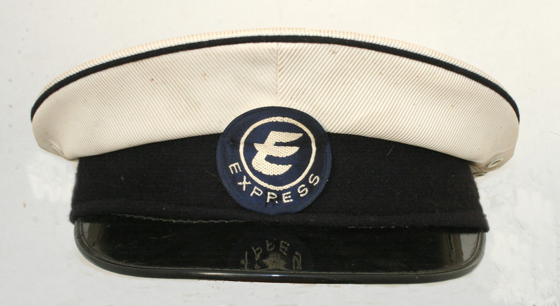 1965 "Original EXPRESS DAIRY milkman's cap with woven fabric cap badge. This style of cap was used by roundsmen from 1965 when the 'E' EXPRESS logo was introduced." (Courtesy Mark Hudson)