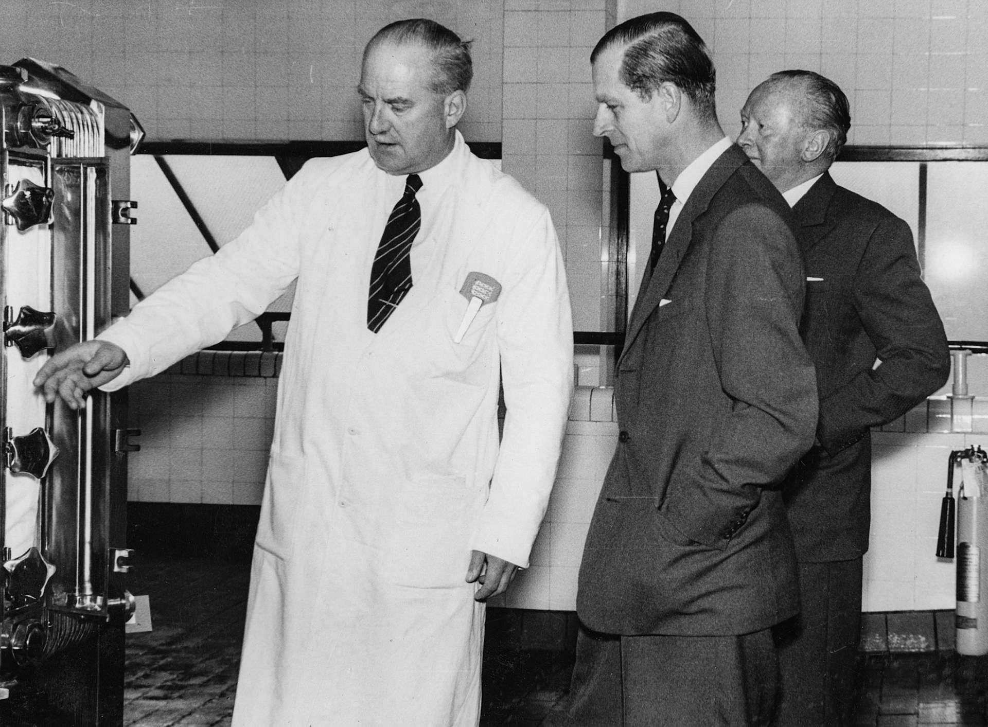 1957 South Morden-Duke of Edinburgh's visit on November 12-Mr T.D, Potter Processing Director explains the operation of a pasteuriser to the Duke, with Walter Nell looking on (Courtesy Paul Luke)