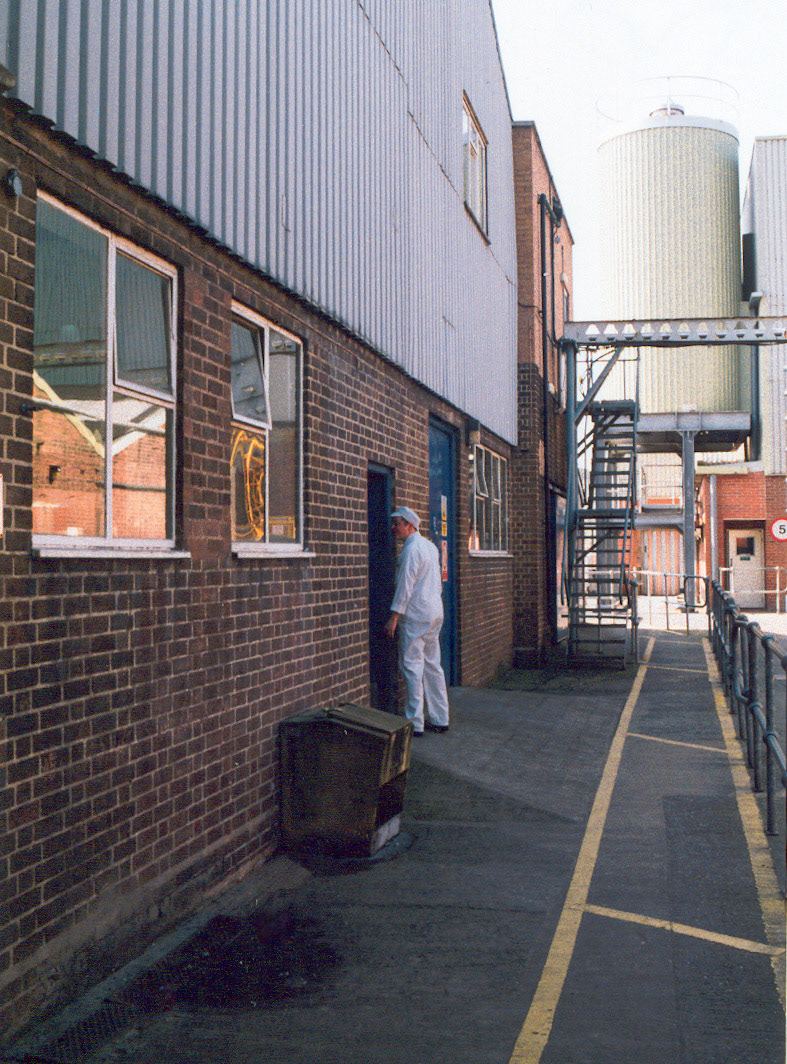 1980's Minsterley Creamery. Tony Swain and Matthew Taylor identify Stephen Crowther by the engineer's workshop.