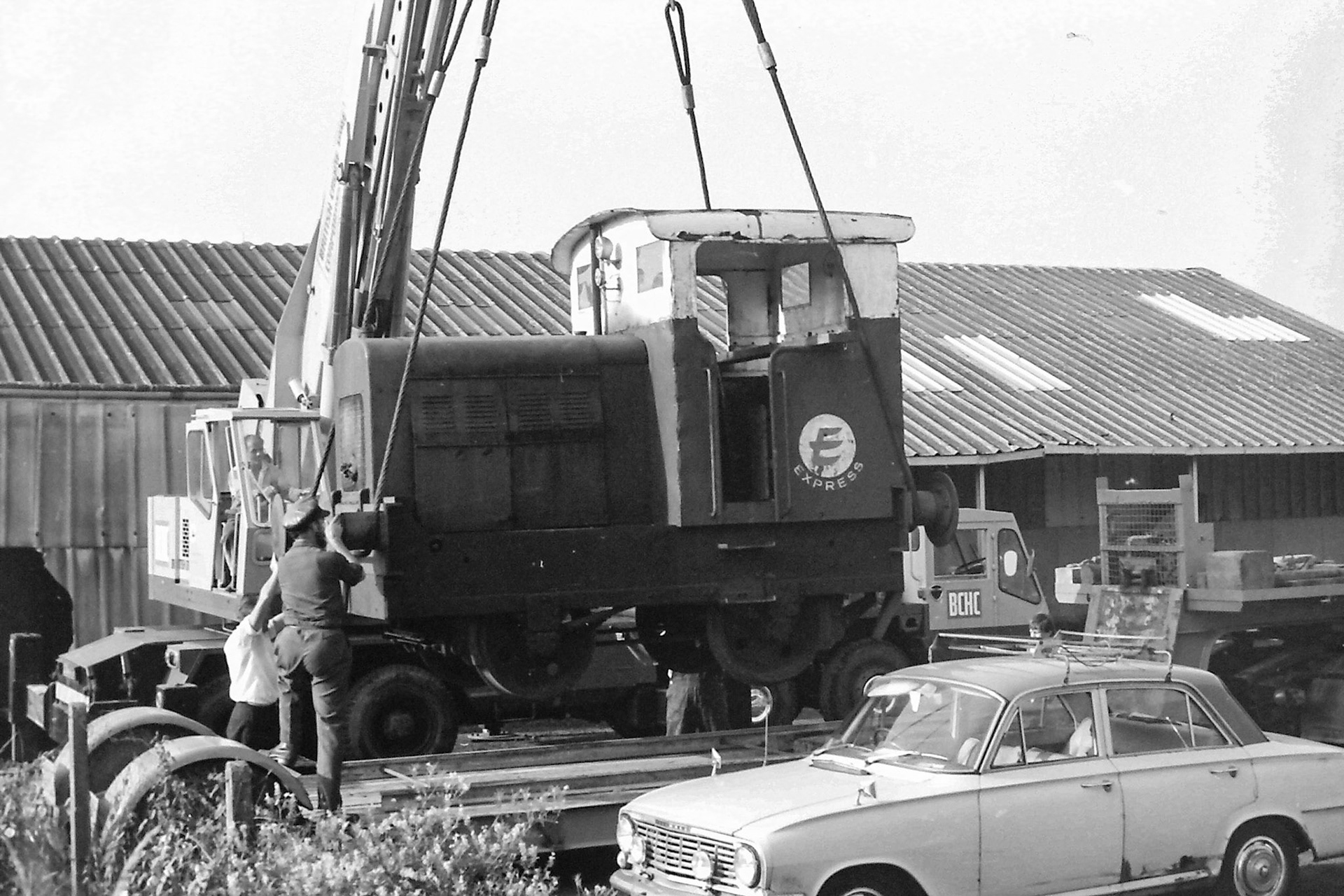 1972 Ruston 48DS 235511 being lifted out by crane into the car park on 26th July to be taken by road to the Ashford Steam Centre. Possibly Brian Wallis, plant engineer, directing the crane in white shirt? Stephen Godden adds "Esmond Lewis-Evans, who ran the South Eastern Steam Centre Ashford, in the foreground helping with the loading after he'd acquired this loco, that's his rusty Vauxhall Victor in front of the trailer." Raffaele Ralph Phillips comments "This shunter was in use when I joined the company in 1970-as an apprentice vehicle electrician I had to check the batteries and some basic electric circuits whilst in service, also checking the charging system on the shunter which involved starting her up! (Picture by Sam Jones, courtesy Geoff Smith)