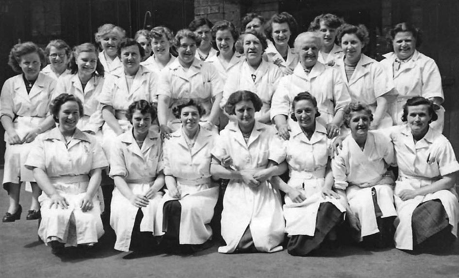 1950's Tuxford &amp; Tebbutt's cheese factory. Phil Krause comments "My Mum, Betty Krause, is bottom left and is 92 this year (2024)." June Bass adds "My dear late mum in the middle of the second row from the back... she looks so beautiful and so happy." Penny Chambers says "Lovely photo of my mum Margaret Chapman, back row 1st right". Vera Gamble adds "My Gran, Win Hack, bottom row middle." Ann Musson identifies "Beatie Ellis on back row, far left, with white hair." (Courtesy Phil Krause)