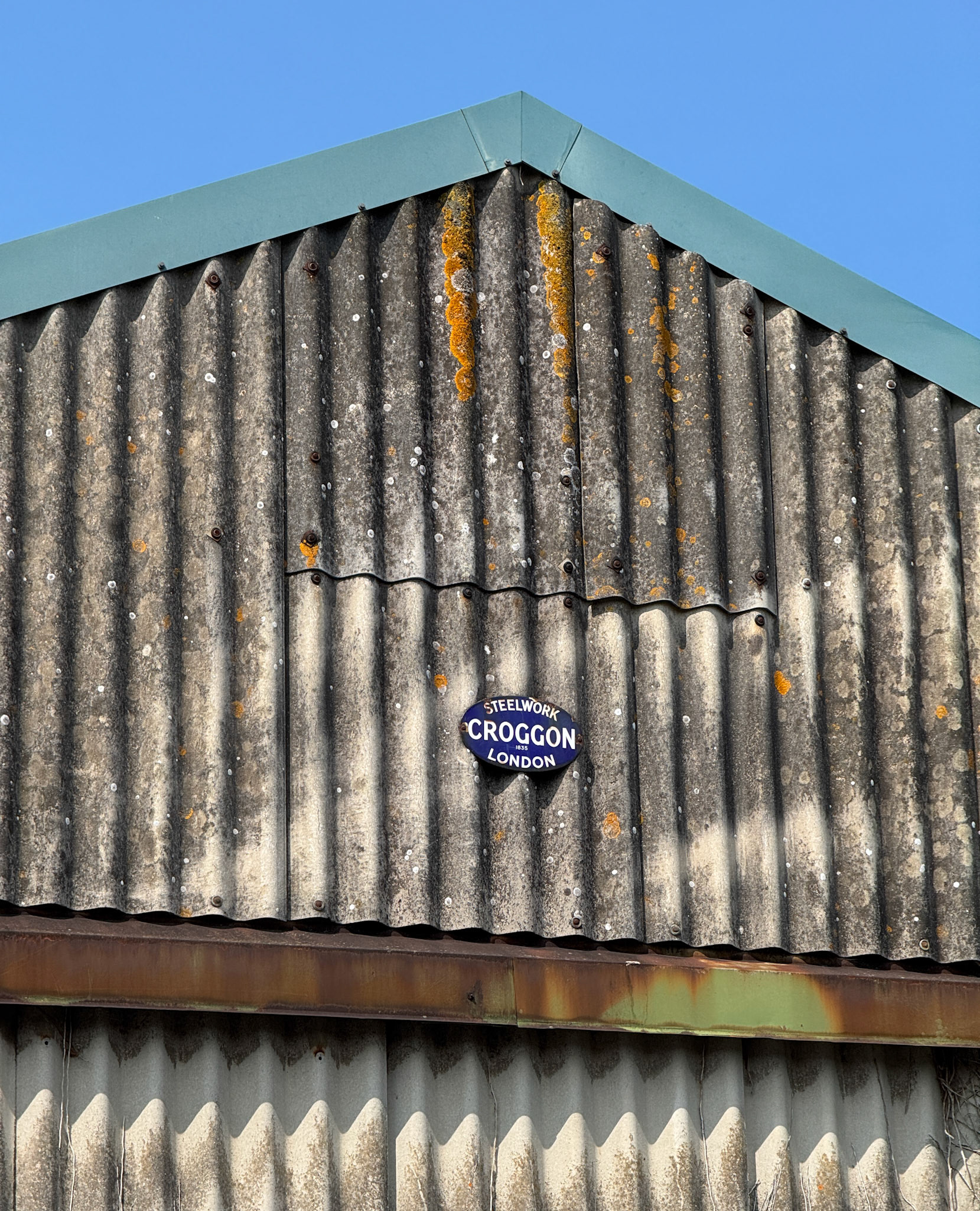 2025 August 05, Billingshurst Station-part of the remaining buildings still in use, which could have been part of the creamery.  Croggan Steelwork of London, established in 1835, may have constructed the original creamery buildings. Croggon and Co were based at 230 Upper Thames Street, London, EC4. (Express Dairy Tales collection)
