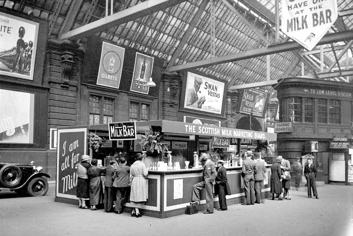 1936 Customers enjoying a glass at the Milk Bar at Glasgow Central Station in 1936. Milk bars, already well-established in USA, were opened across the UK by the Milk Marketing Boards in the 1930’s. (Courtesy Glasgow City Archives, Ref: D-CA 8/132)