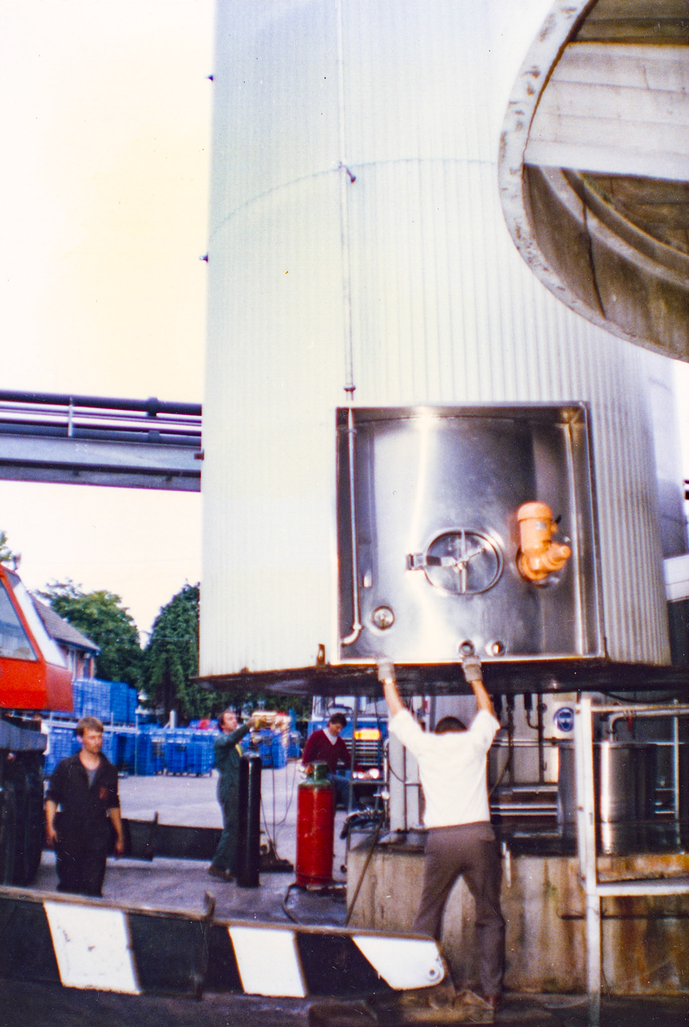 1980s Exeter Processing-silo and milk reception construction. Jimmy Reid recognises Peter Perry (holding up the silo), Engineering Manager. (Pictures by Syd Johnston, presented by his son Ian via Teresa Heal)