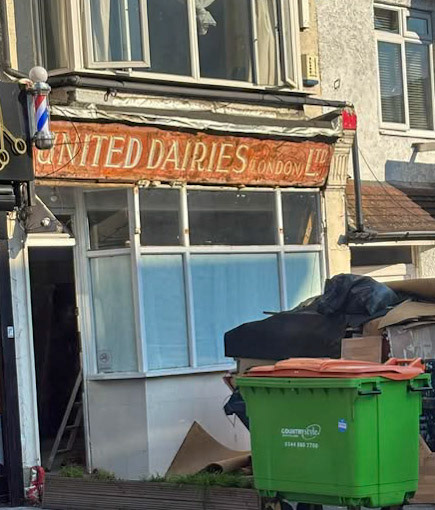 2025 United Dairies shop sign exposed, Stafford Road, Wallington, Surrey