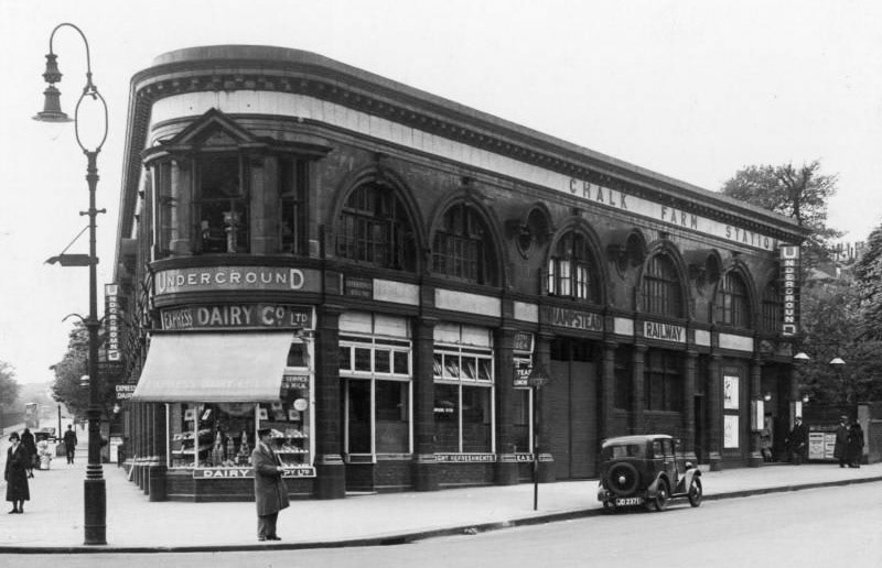 1933 Chalk Farm Underground station, Northern line, a Leslie Green corner site building; showing the Haverstock Hill side. Express Dairy shop and tea room occupies the corner, a station entrance is located to the far end, another entrance in the centre is shuttered up. View up Adelaide Road on opposite side of road by camera. (Courtesy London Transport Collection)