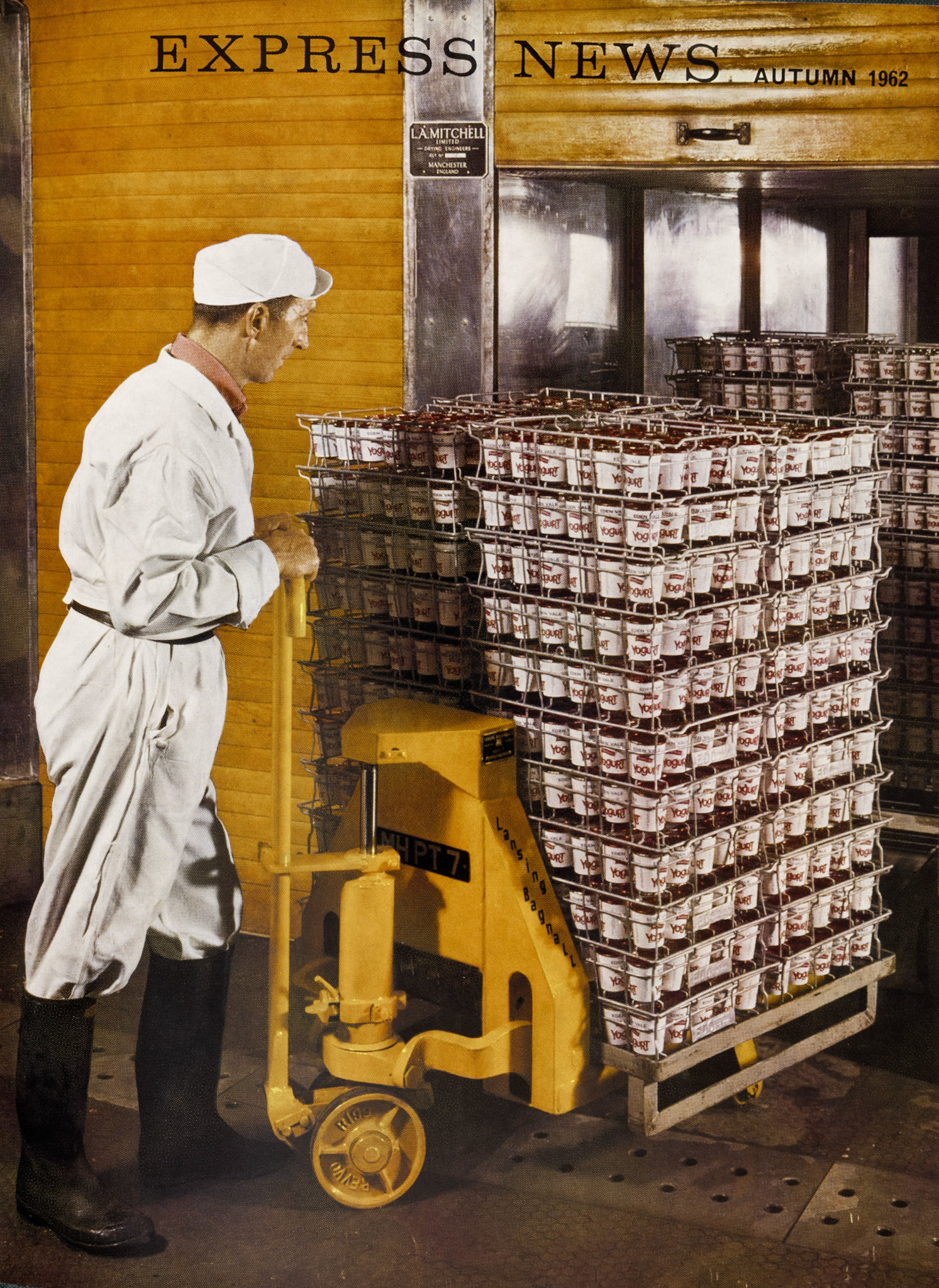 1962 Cricklewood Filling-room Hand Mr Denis O'Connor wheels a stillage of raspberry-flavoured yogurt into one of the eight incubating ovens. The new plant in Number 2 dairy is designed to keep pace with our expanding sales, which we hope will rise to a million cartons a week in the London area. (Express News Autumn, Front Cover)