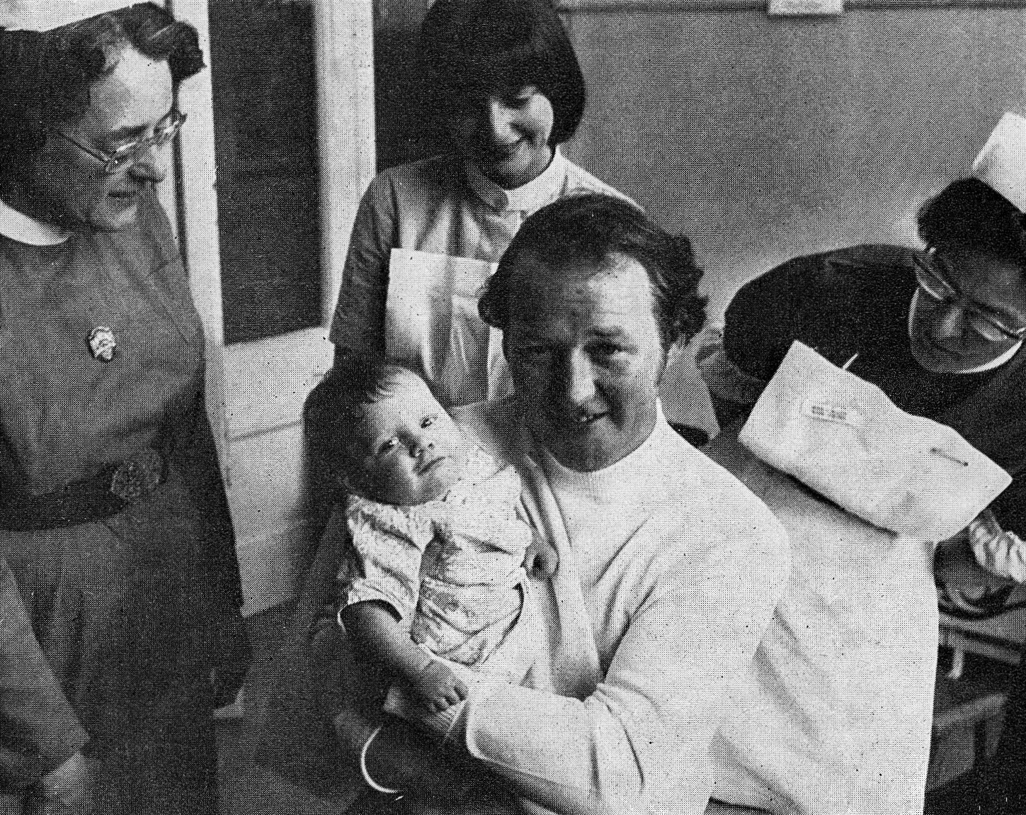 1976 Bradford's Derek Hall, a father of three, heard cries from a tiny bundle lying beside the side door of a church in the early hours of a particularly cold morning. An active 31, Derek was already half-an-hour ahead on his round, and it was matter of seconds before he had the bundle - 'My name is Tara. I am 5½ months old' according to the note attached. Pictured here with his unofficial mate in Bradford Childrens' Hospital, Derek declared 'I never expected to deliver a baby'. 'Well done', and at the same time sympathise with supervisor Peter Stubbs who was forced to take over the round for a while. Lisa Hall comments "This was my Dad, sadly passed away nearly 23 years ago. I remember the reporters coming to the house and a short news report on Look North." Adie Mandy Mclear added "Uncle Derek, my mom’s brother." Hayley Mclear "This is my Uncle Derek 🥰. There was an article in the Telegraph &amp; Argus, also a piece on local news. He was my Mum's brother &amp; we spent a lot of our childhood with him and his family." (Express News Summer)