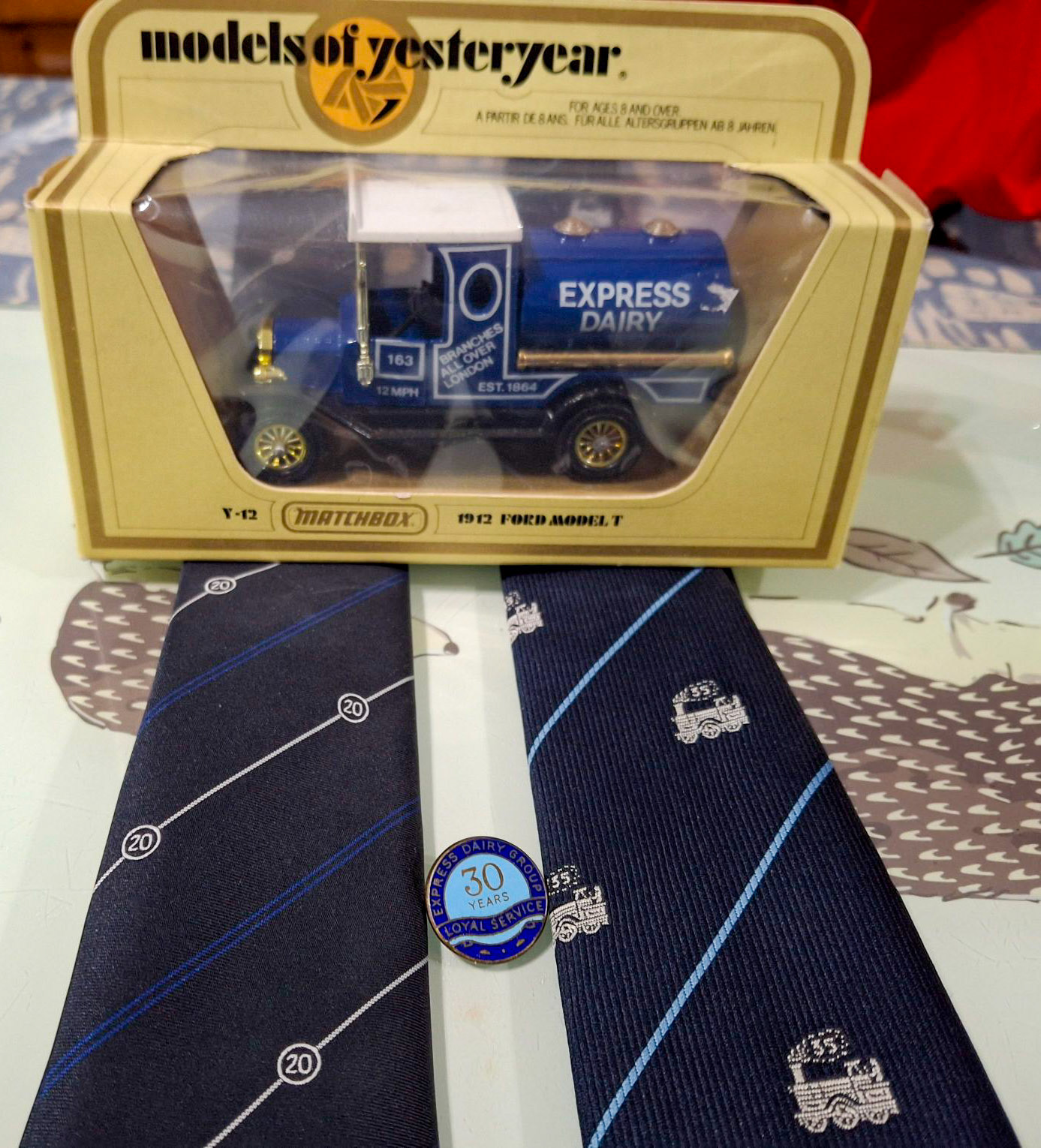 1980s? Cricklewood. Alan Snellings writes "My 20 year tie and my Dad's (Joe Snellings) 35-year tie and pin. I gave my Dad's 30 year watch to my son. My Dad drove the old Commer trucks out of Cricklewood during the 60s; I worked there for 23 years and finished up driving Volvo F10 after the Ford D Series and AEC Seddon." Antony Simmons comments "When I started at Cricklewood, Alan’s dad Joe worked in the garage, which is where I started. He was such a funny man and used make me laugh so much-I was a 16 year old apprentice and he used to have me making him tea all day long. Fantastic memories of the site and individuals like Joe. My father was Ken Simmons, and my brother, also Ken, worked at the dairy. My uncle Tony Denton was the shop steward, now lives in Norfolk". (Courtesy Alan Snellings)