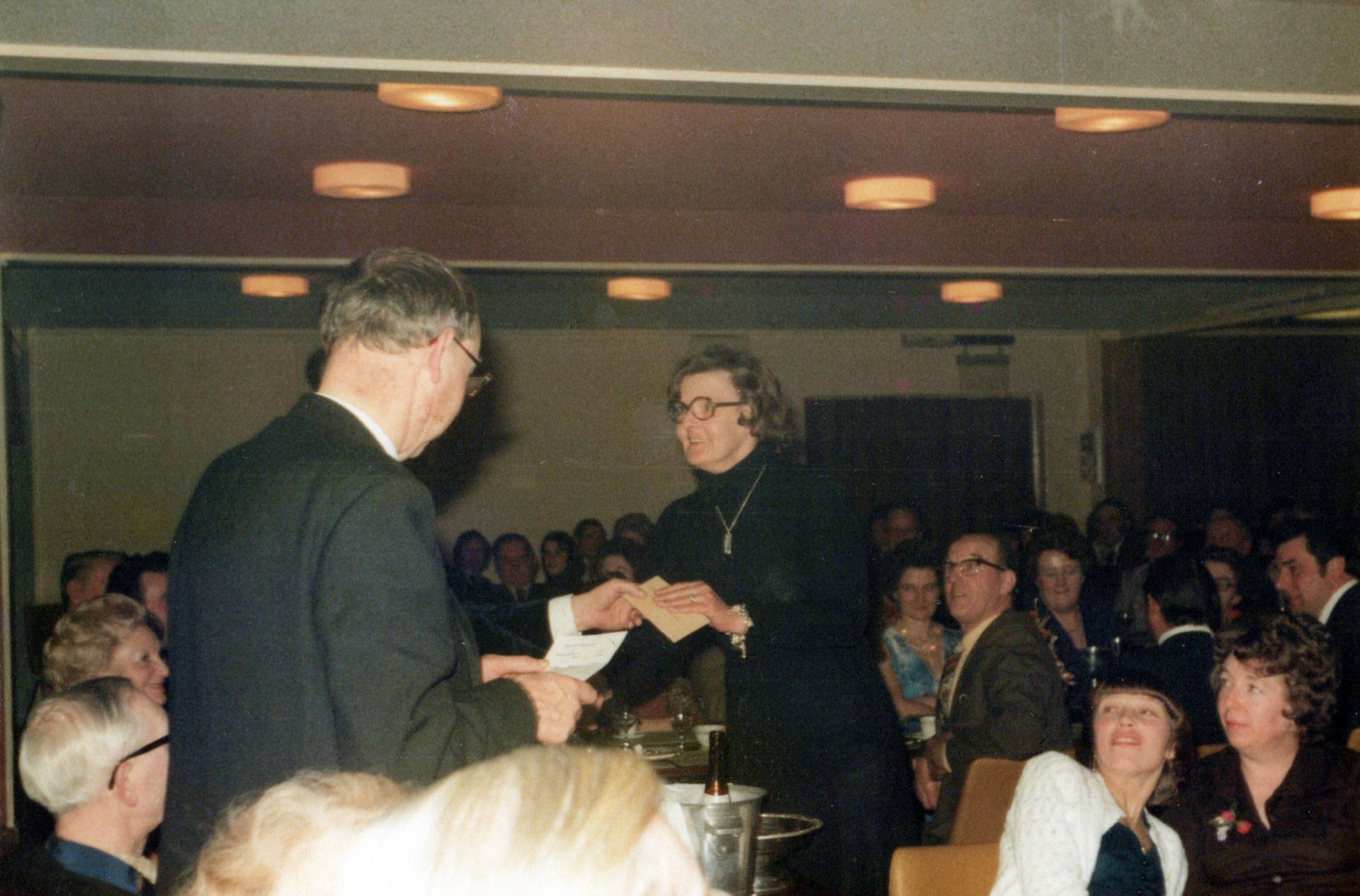 1980's Minsterley Bowling Club. Lorraine Fletcher comments "Gerda Lyons, Joe's wife taking the envelope, she was a good friend of mums, me and my sister Debbie Llewellyn used to love going to their house for drinks and a look at their beautiful garden; they lived just up the road from us." Harry Evans adds "Robin Lehman with his back to us". Kenneth Carswell adds "Wendy Lakelin, bottom right" and Anthony Gray adds "That's my mum Wendy, was just shocked how young she was and tbh the hair 🤣 (Courtesy Joe Lyons)