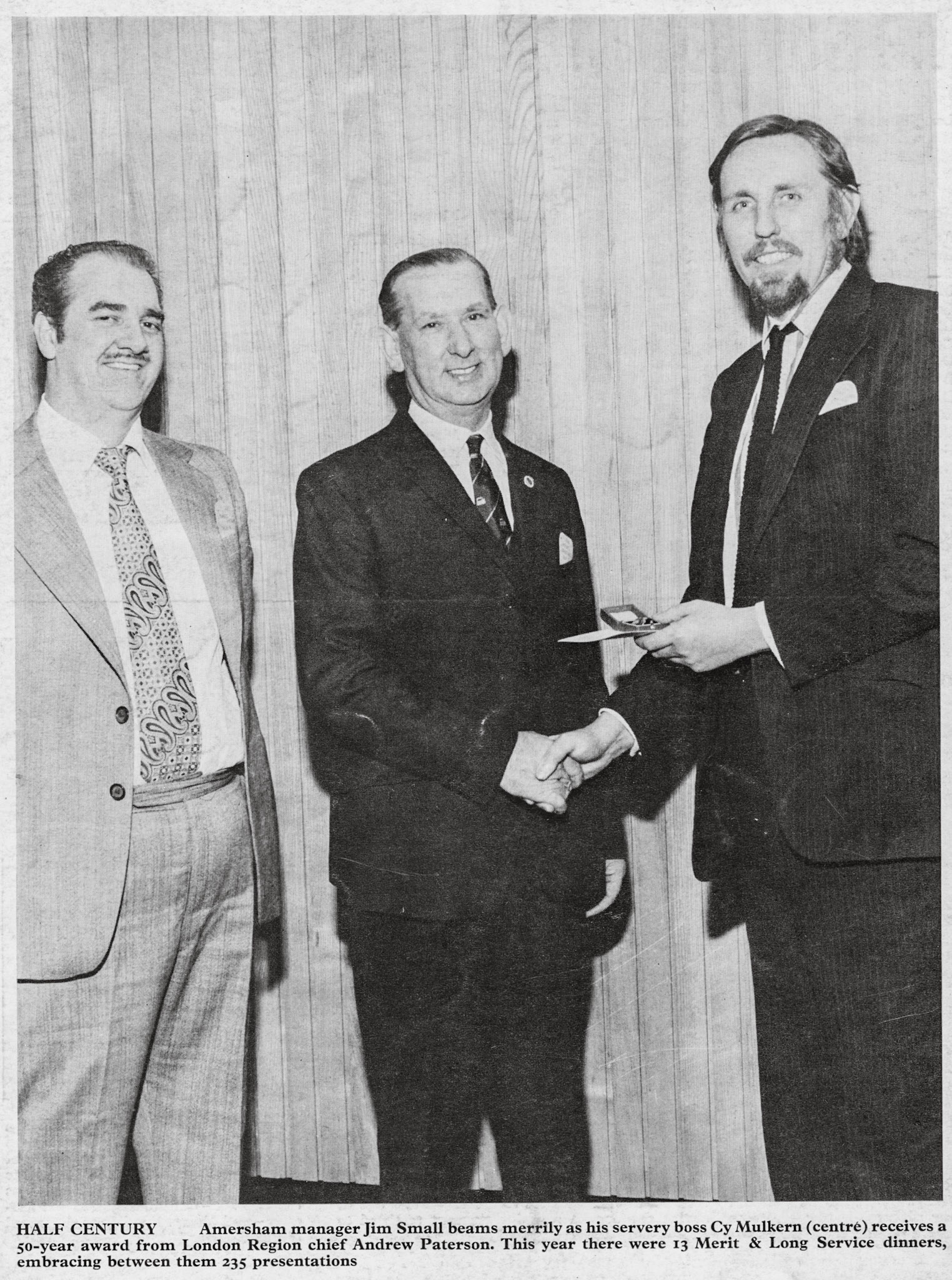 1975 Amersham Manager Jim Small (left) beams as his servery boss Cy Mulkern receives a 50year award from London Region Director Andrew Patterson