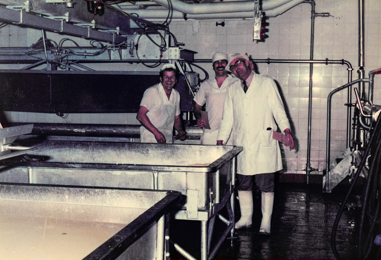 1960 Minsterley. John Potter and Tony Swain identify Dave Ingram, in the cheese starter room. Peter Davies adds "middle is Paul Bevan? The manager is Harold Ford". Nigel Braley comments "Lovely photo, Joe Lyons was always taking photos. I started in the Chemi lab as I turned 25 in 1978." (Courtesy Joe Lyons)