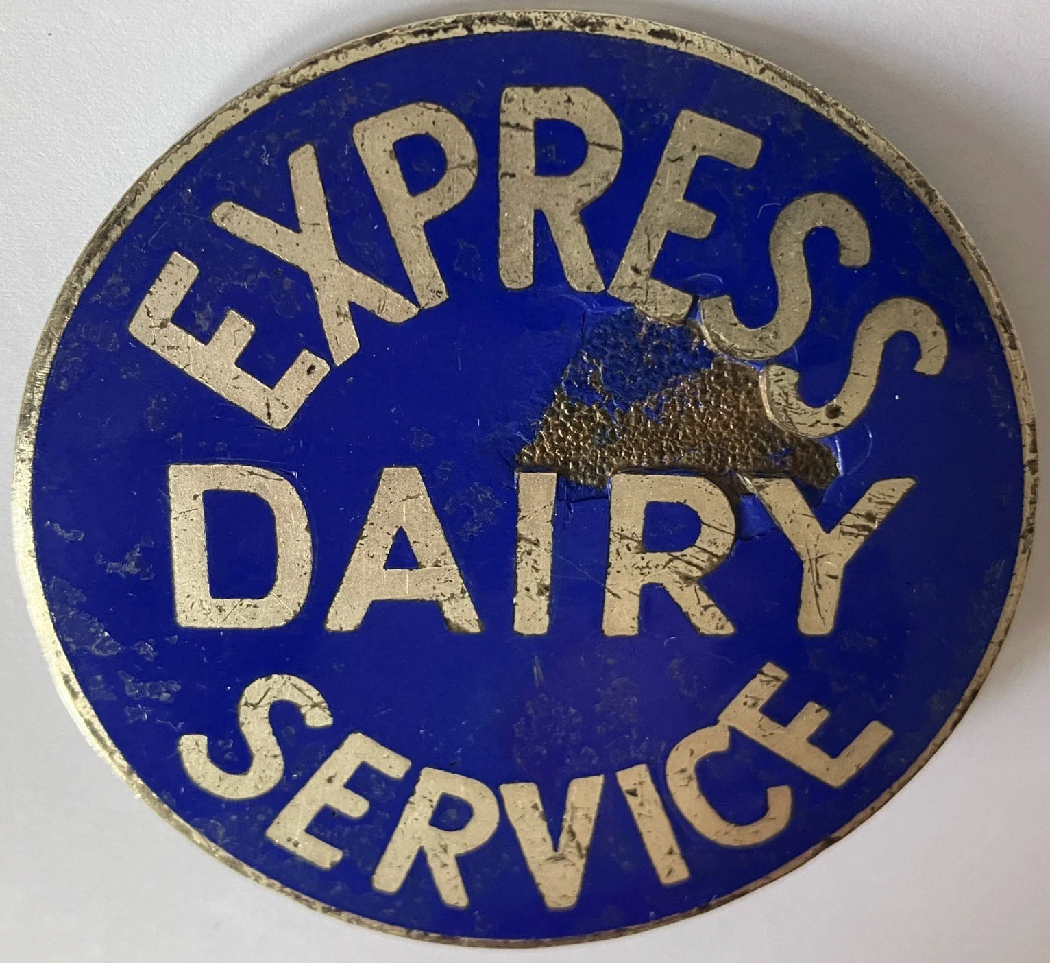1930's? Express Dairy Service badge, enamelled, approx. 65mm in diameter. Graham Baker comments "I believe these were tanker drivers cap badges". (eBay for sale)