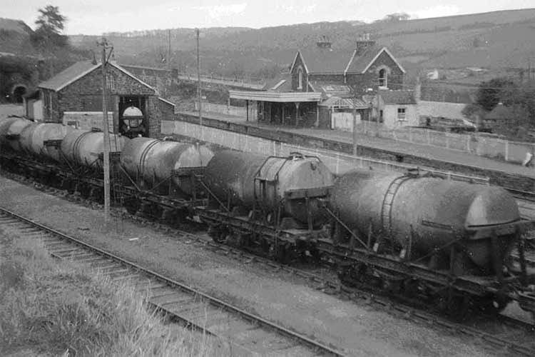1965 An overall view of Torrington station, shortly after the passenger and general goods services had been withdrawn. Milk tankers bound for London are prominent in the yard. Photo: Nigel Brodrick