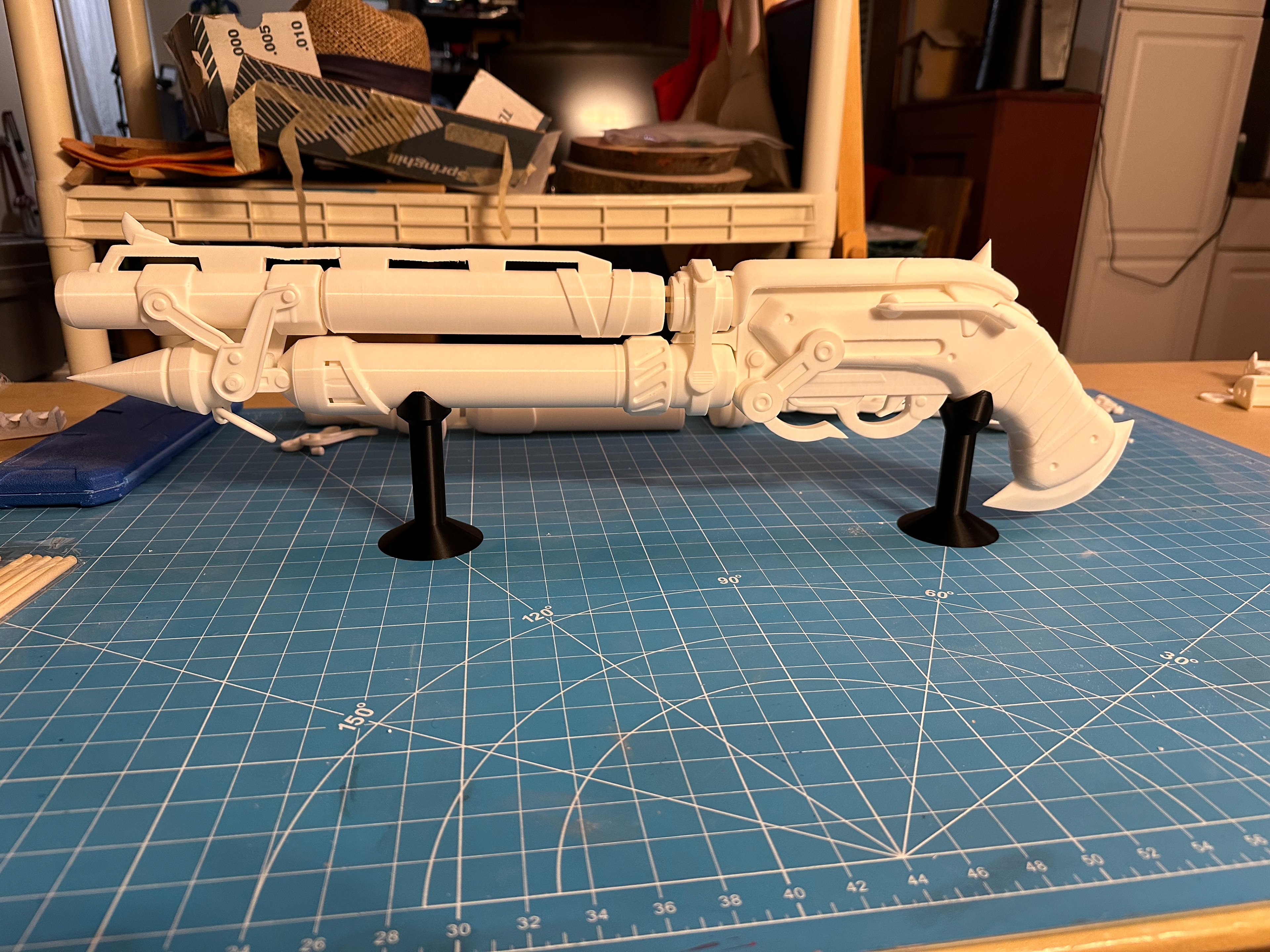 Raw 3D printed pieces of Junker Queen's shotgun assembled on stands