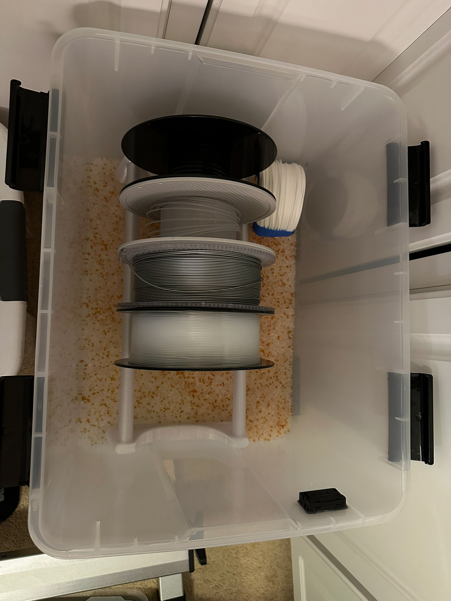 Dry box filament spool rack in dry box holding spools top down view
