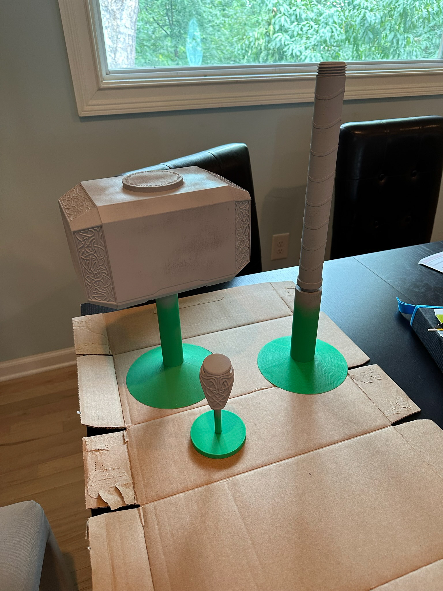 Mjolnir parts on painting stands with primer