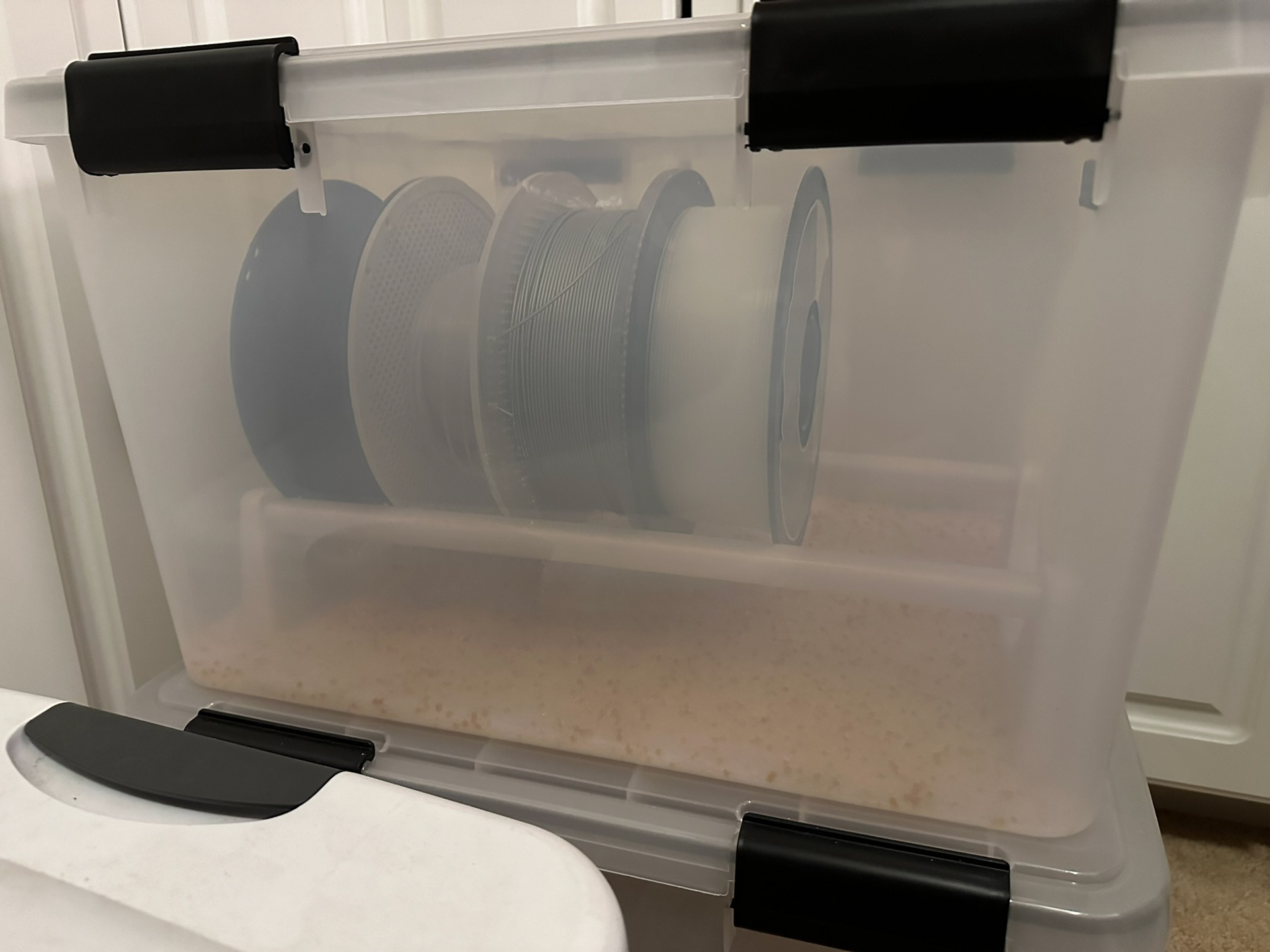 Dry box filament spool rack in dry box holding spools side view