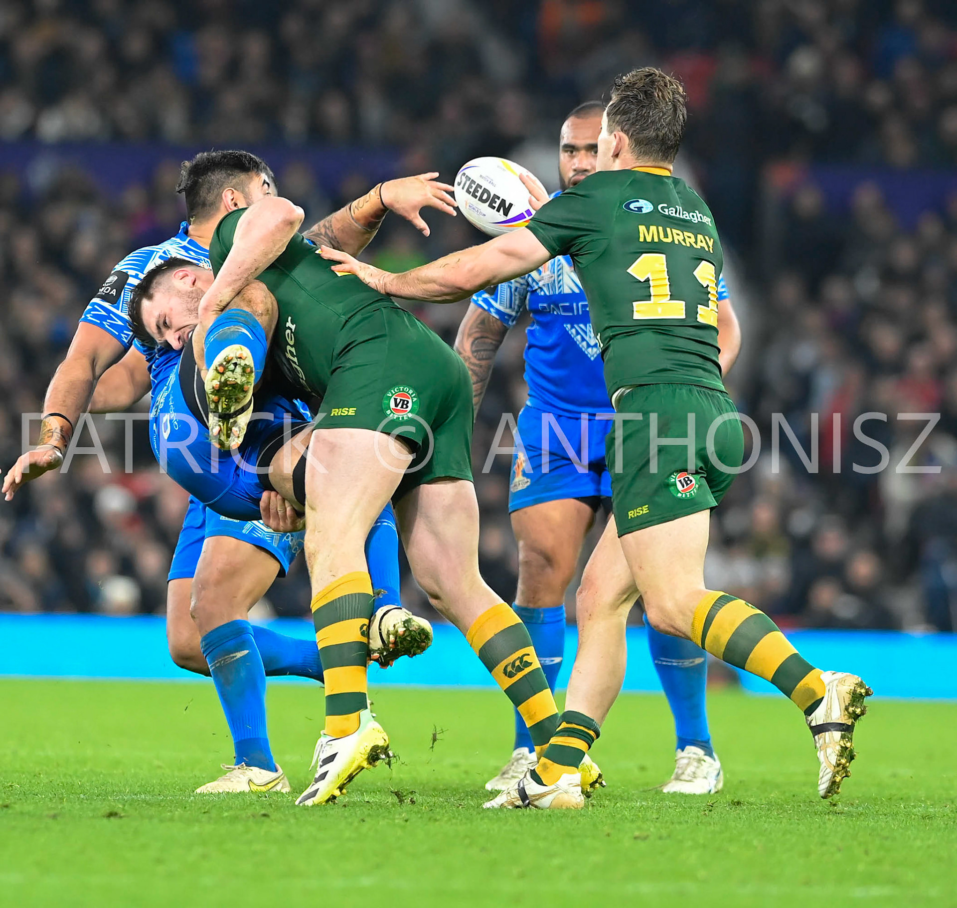Manchester   ENGLAND - NOVEMBER 19.Angus Crichton of Australia brings down Royce Hunt of Samoa as he tries to pass the ball during  the Rugby league World Cup Mens Final  between Australia and Samoa at the  Old Trafford Stadium on November 19 - 2022 in Manchester England.
