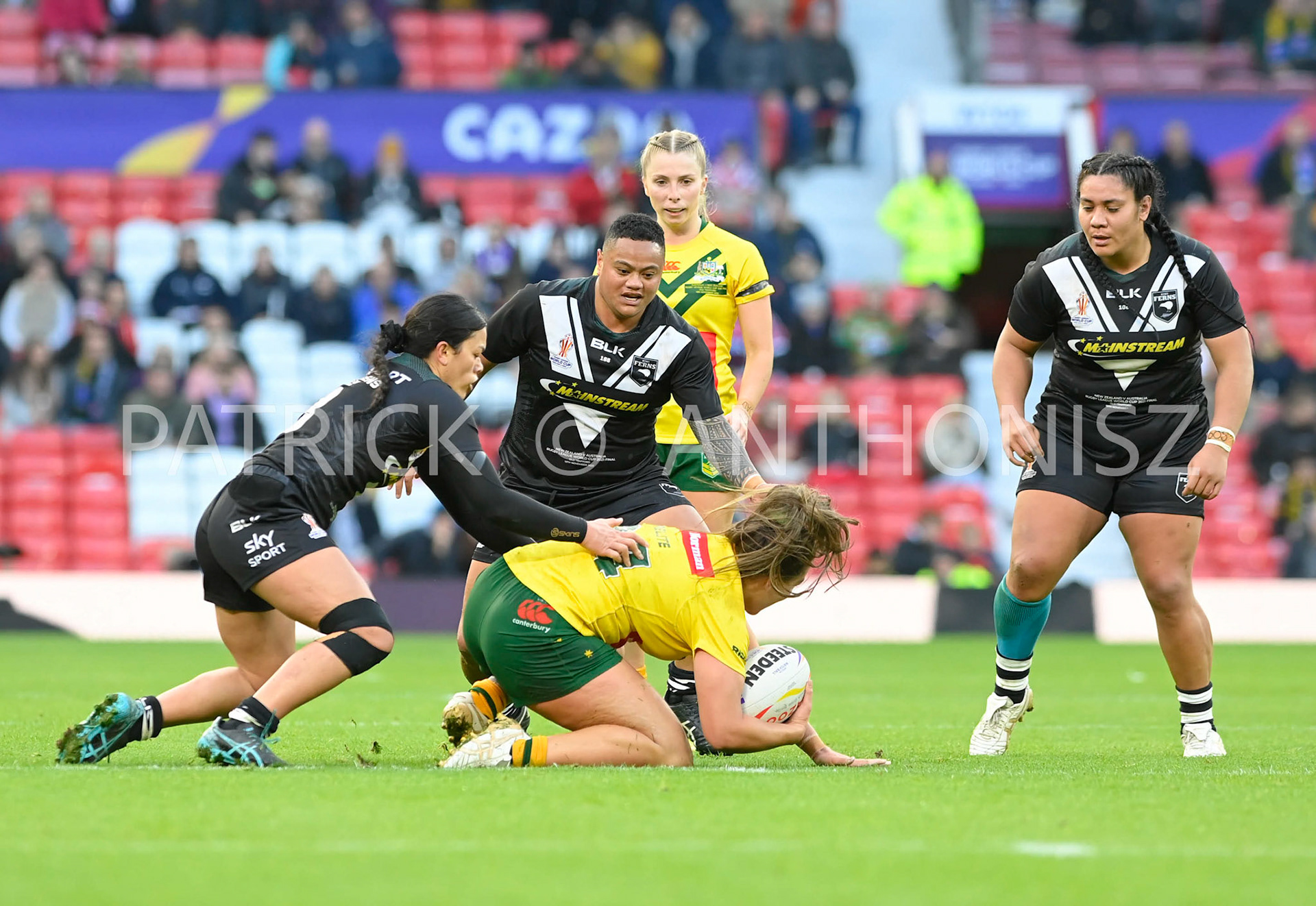 Manchester   ENGLAND - NOVEMBER 19.Evania Pelite  of Australia  tries to keep hole of the ball from the  New Zealand defence during  the Rugby league World Cup Womens Final  between Australia and New Zealand  at the Old Trafford   on November 19 - 2022 in Manchester England.
