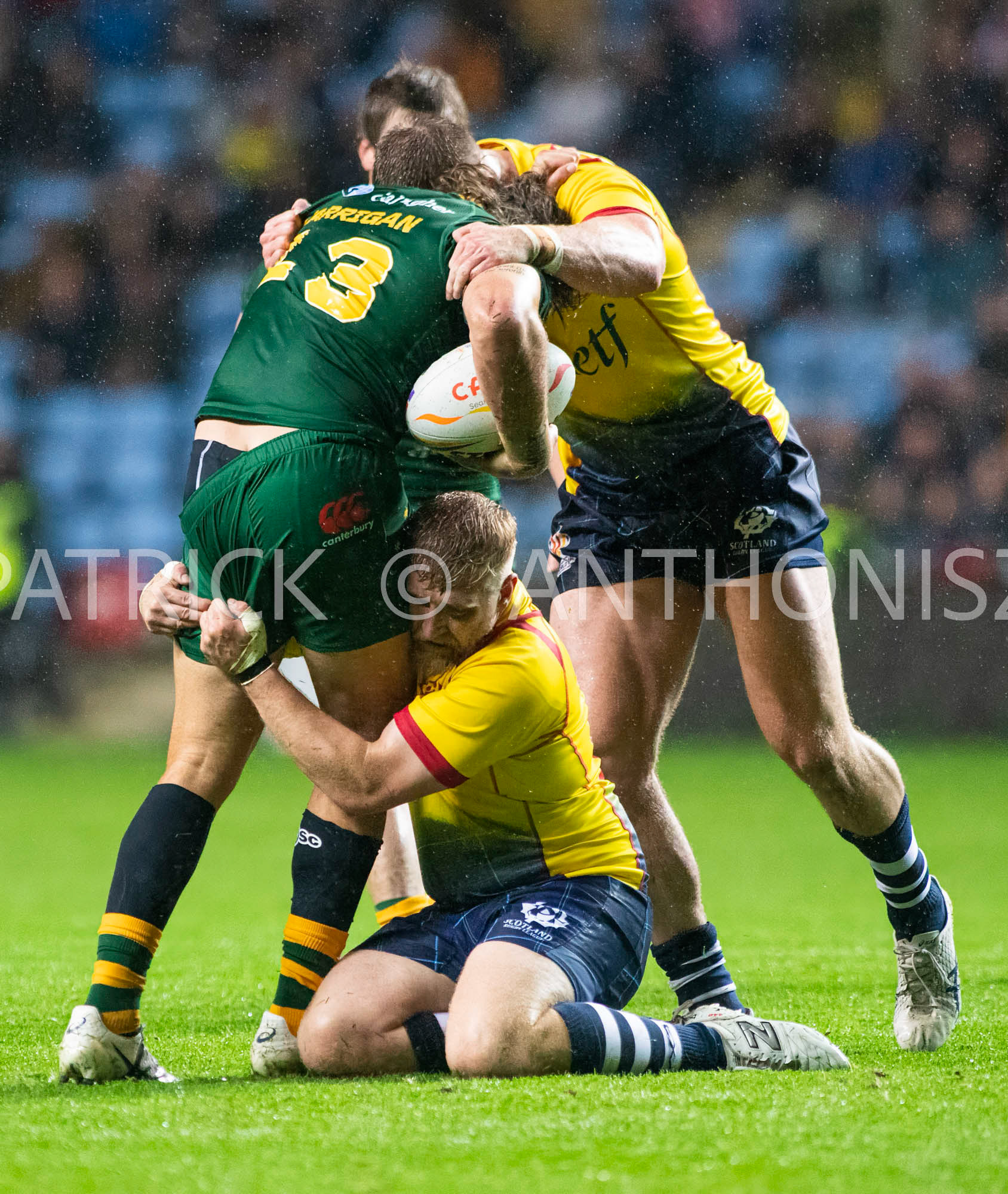 Coventry England  21st October: Patrick Carrigan of Australia is held by Jack Teanby and Logan Bayliss-Brow during the Rugby League World Cup 2021 between Australia Vs Scotland  at  Coventry Building Society Arena on 21st October 2022 Australia 84: Scotland 0