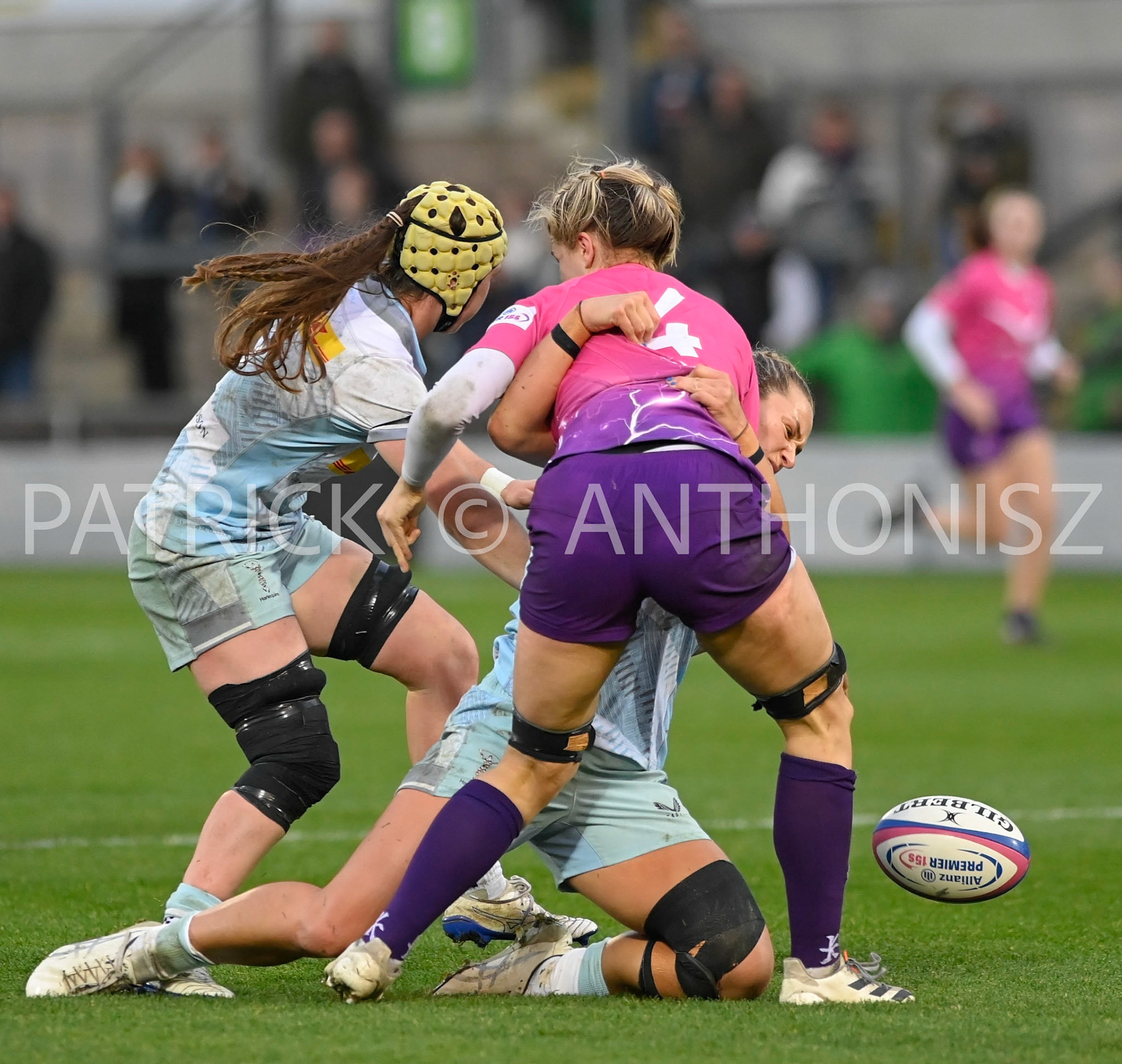 NORTHAMPTON, ENGLAND- Nov -27 - 2022 :  Lilli Ives Campion of Loughborough Lightning brought down by Emily Roboinson (vc) and Bella McKenzie  of Harlequins during the match between Loughborough Lightning Vs Harlequins at Franklin's Gardens on November 27, 2022 in Northampton, England