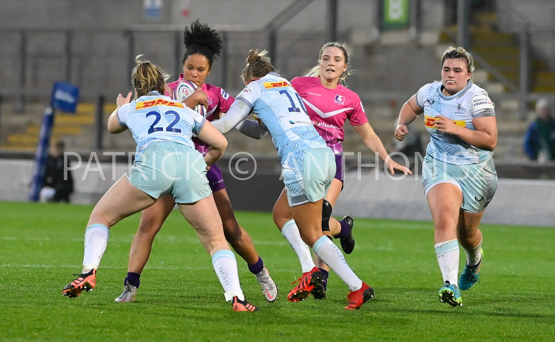 NORTHAMPTON, ENGLAND- Nov -27 - 2022 : Detysha Harper  Loughborough Lightning tries to get away from Beth Blacklock and Emily Scott of  Harlequins during the match between Loughborough Lightning Vs Harlequins at Franklin's Gardens on November 27, 2022 in Northampton, England