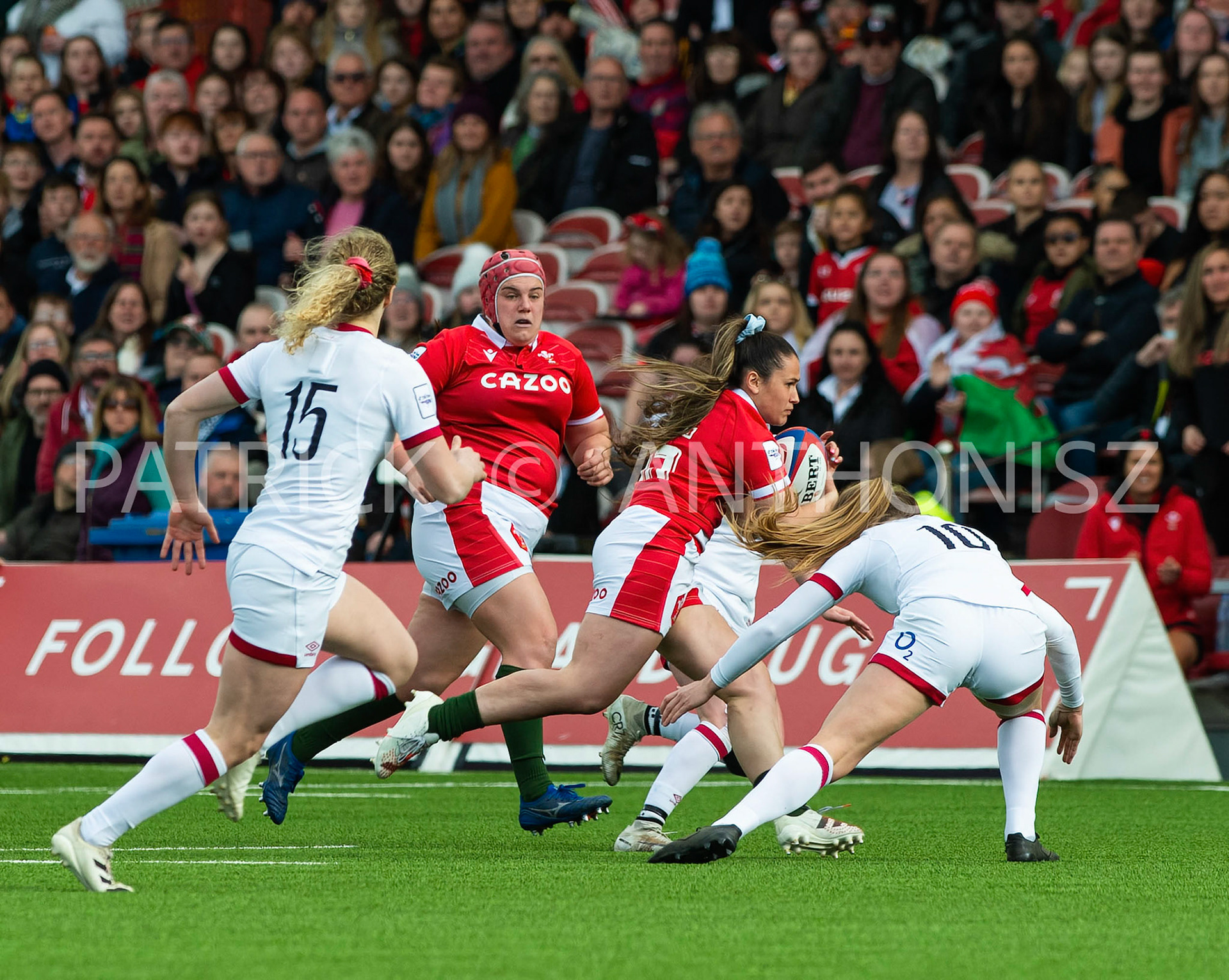 England Vs Wales Six Nations Gloucester 9 April 2022.Kayleigh Powell of Wales tries to get away from no 15 Abigal Dow of England and no 10 Zoe Harrison of England during the  TikTok Women's Six Nations Rugby Championship match, England Red Roses Vs Wales  Rugby at the Kingsholm  Stadium Gloucester