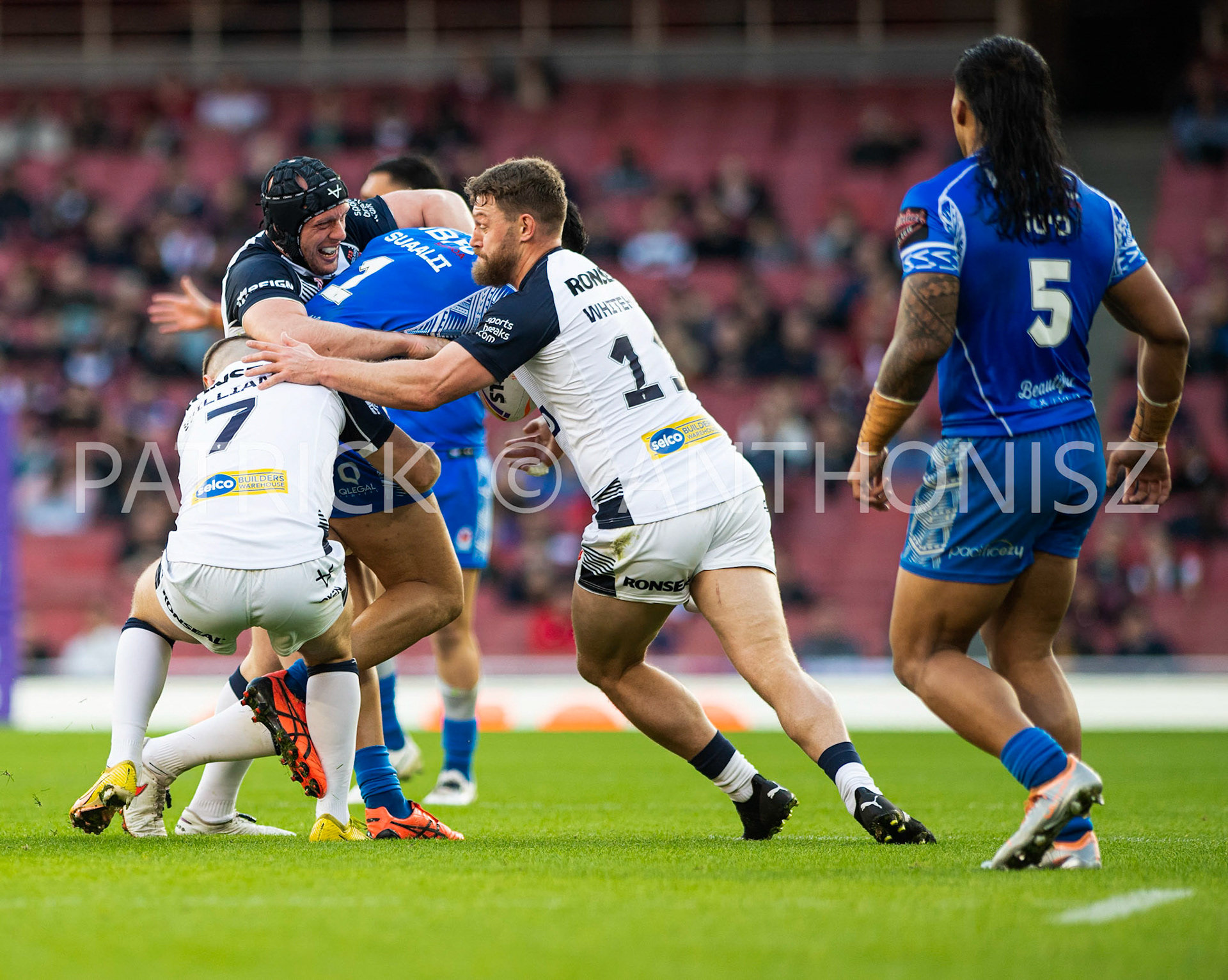 London  ENGLAND - NOVEMBER 12 George Williams of England and Elliott Whitehead of England brings  down Joseph Suaali'i of Samoa during  the  Semi Final between England and Samoa at the Emirates Stadium on November 12 - 2022 in London, England.