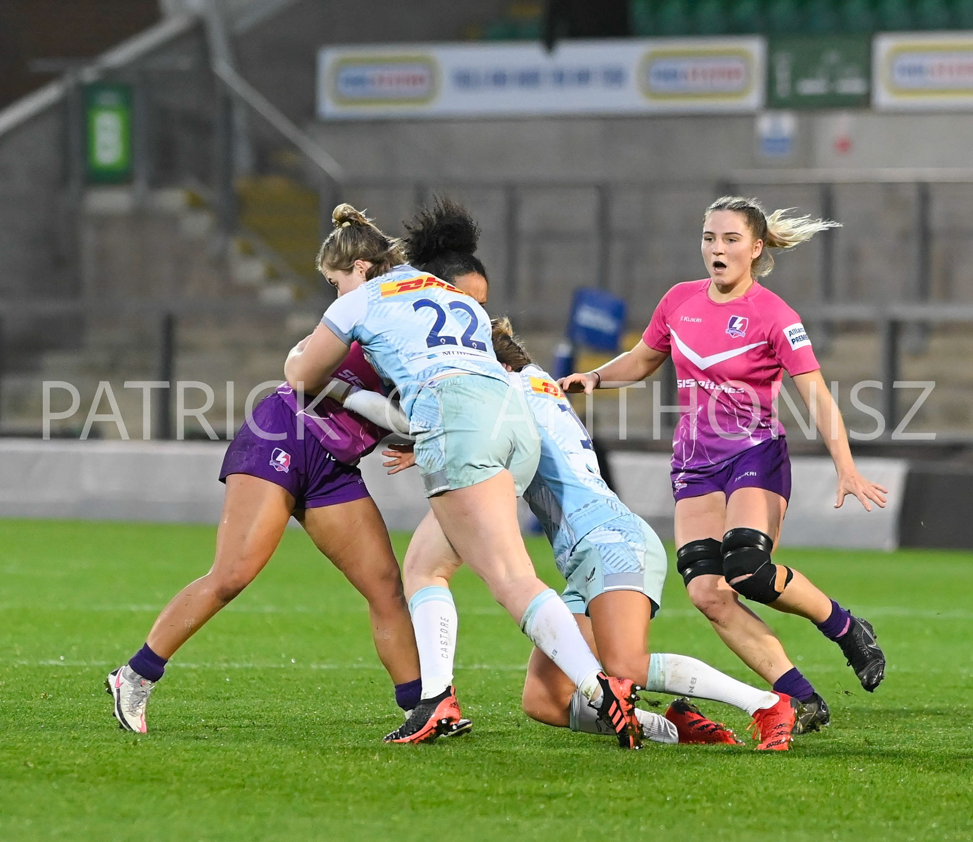 NORTHAMPTON, ENGLAND- Nov -27 - 2022 : Detysha Harper  Loughborough Lightning tries to get away from Beth Blacklock and Emily Scott of  Harlequins during the match between Loughborough Lightning Vs Harlequins at Franklin's Gardens on November 27, 2022 in Northampton, England