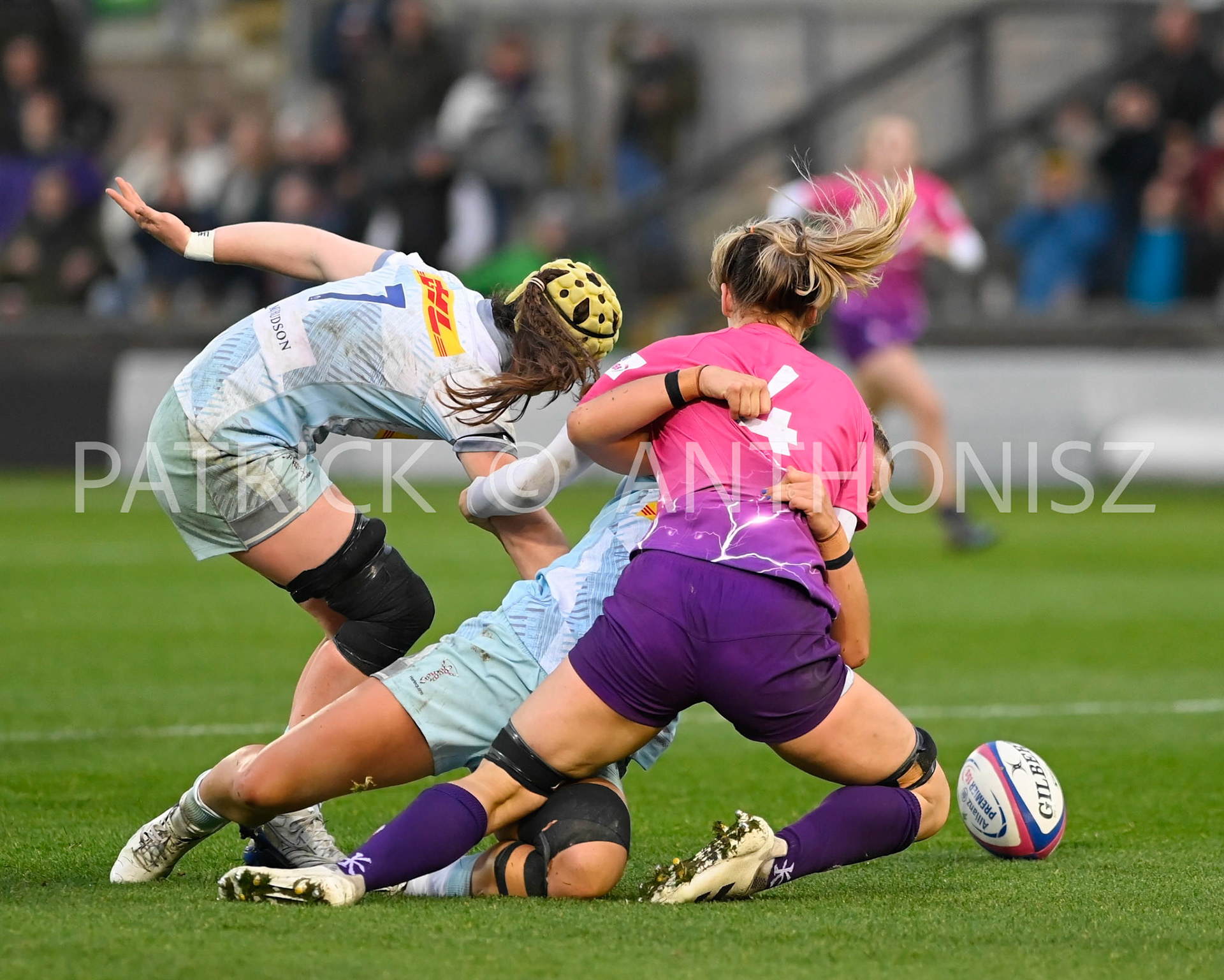 NORTHAMPTON, ENGLAND- Nov -27 - 2022 :  Lilli Ives Campion of Loughborough Lightning brought down by Emily Roboinson (vc) and Bella McKenzie  of Harlequins during the match between Loughborough Lightning Vs Harlequins at Franklin's Gardens on November 27, 2022 in Northampton, England