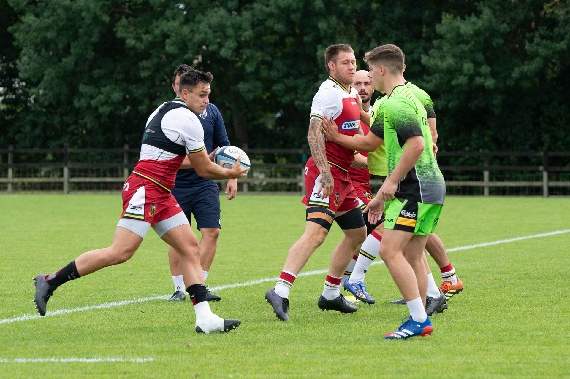 Tom  Collins runs with the ball  on training day at the Northampton Saints training session at Franklin's Gardens