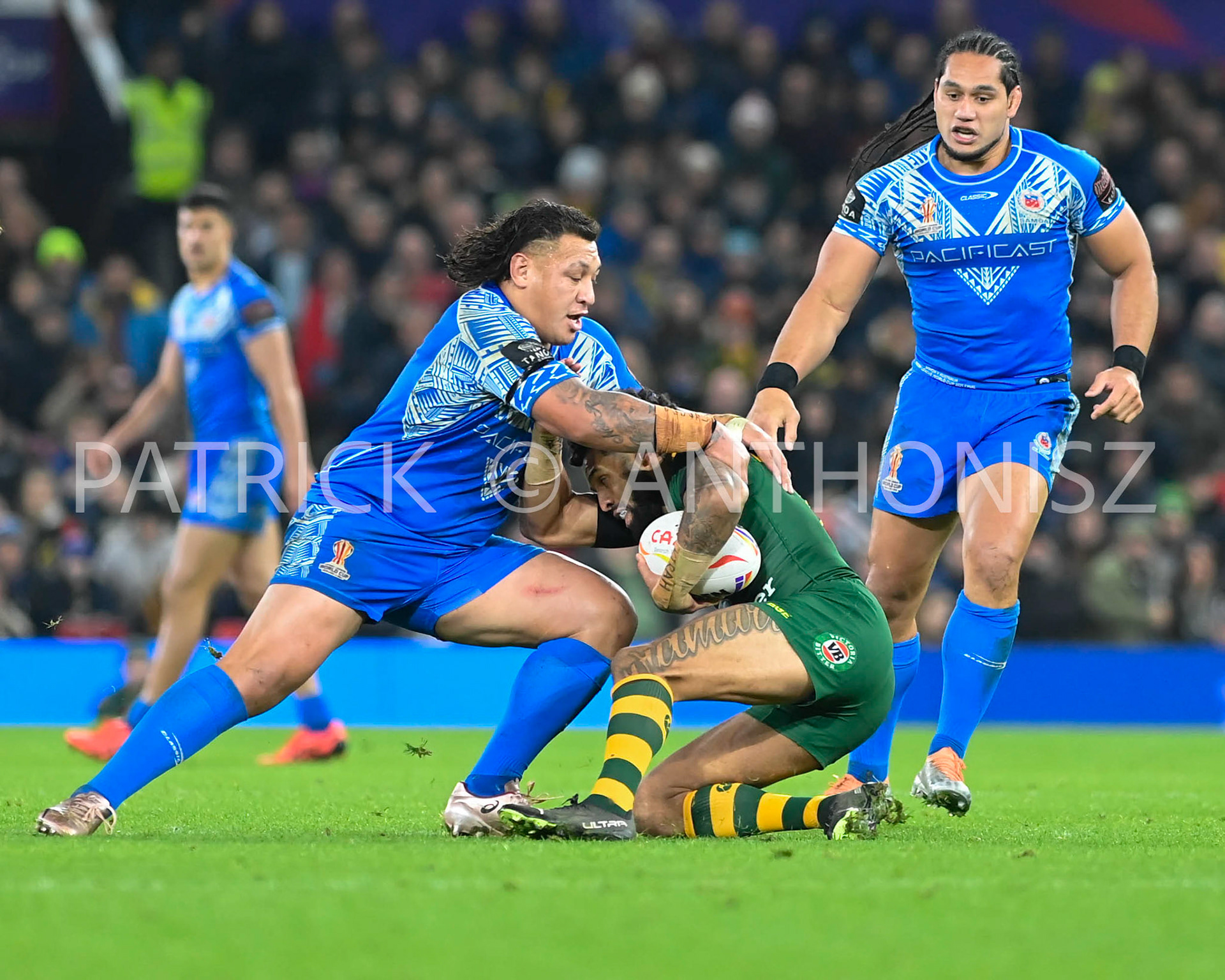 Manchester   ENGLAND - NOVEMBER 19.osh Addo-Carr of Australia is stop by  Josh Papali'i of Samoaduring  the Rugby league World Cup Mens Final  between Australia and Samoa at the   Old TraffordStadium on November 19 - 2022 in Manchester England.