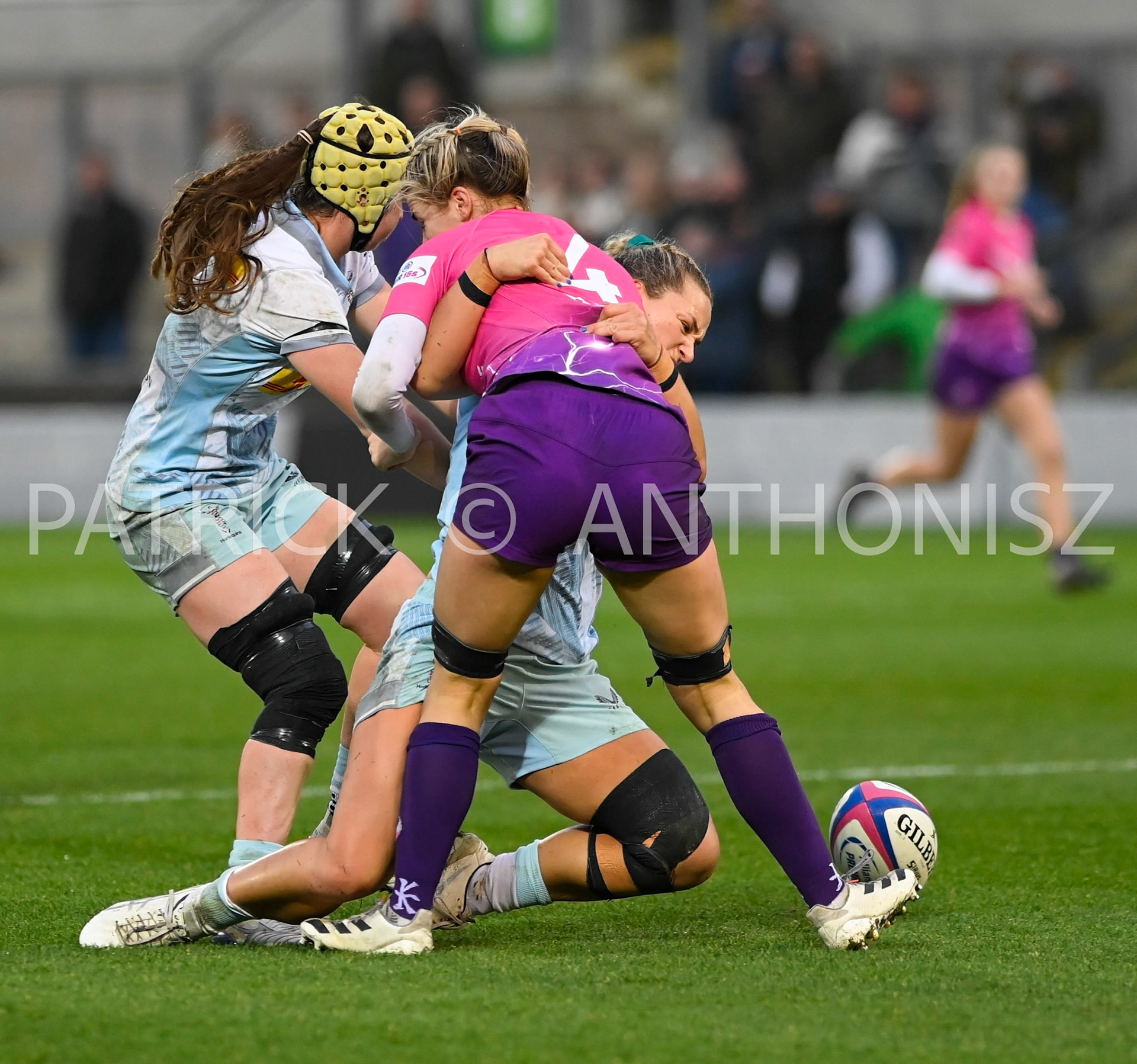 NORTHAMPTON, ENGLAND- Nov -27 - 2022 :  Lilli Ives Campion of Loughborough Lightning brought down by Emily Roboinson (vc) and Bella McKenzie  of Harlequins during the match between Loughborough Lightning Vs Harlequins at Franklin's Gardens on November 27, 2022 in Northampton, England