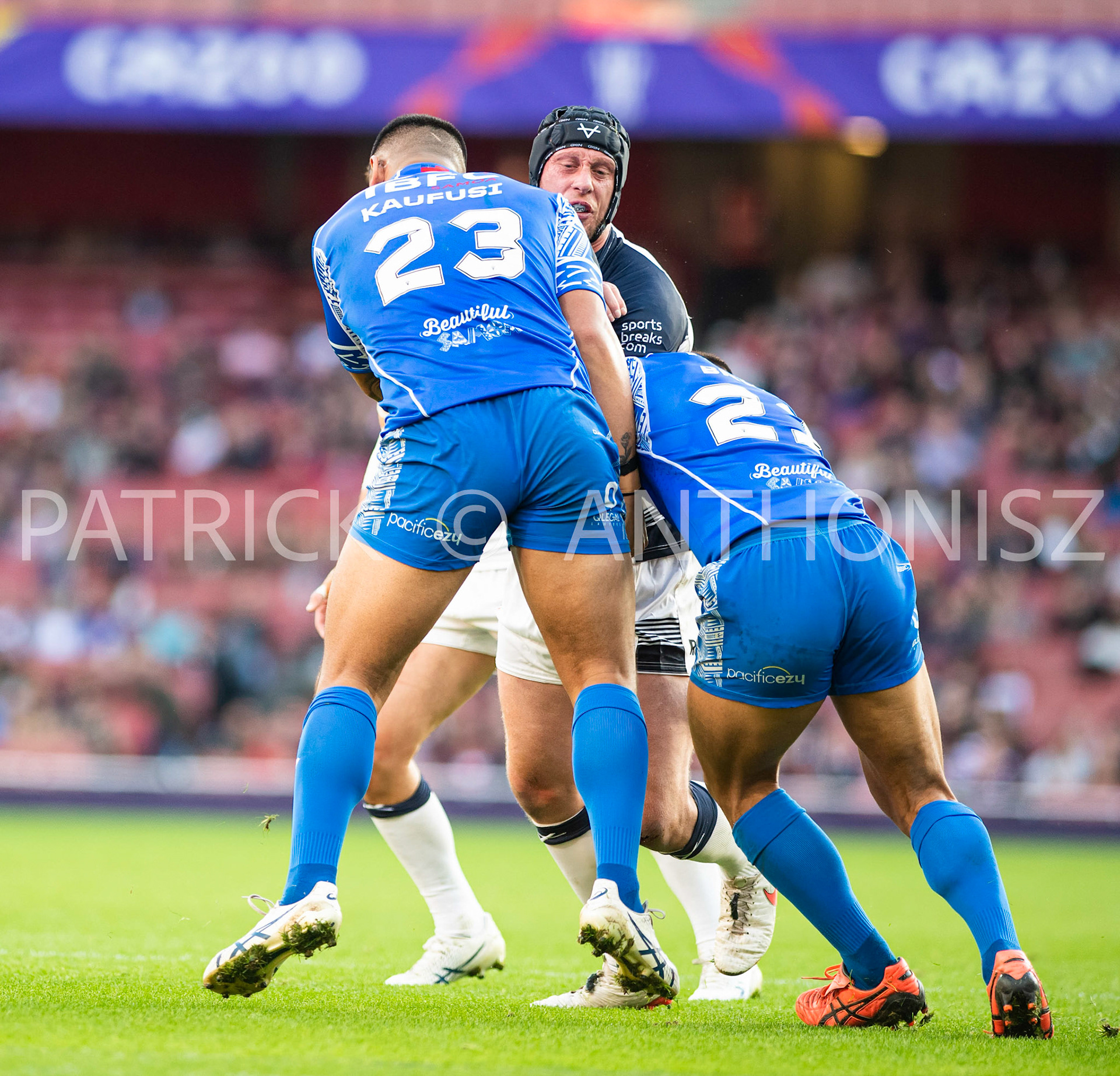 London  ENGLAND - NOVEMBER 12 Chris Hill of England  under attack by Jaydn Su'a of Samoa and Fa'amanu Brown of Samoaduring  the  Semi Final between England and Samoa at the Emirates Stadium on November 12 - 2022 in London, England.