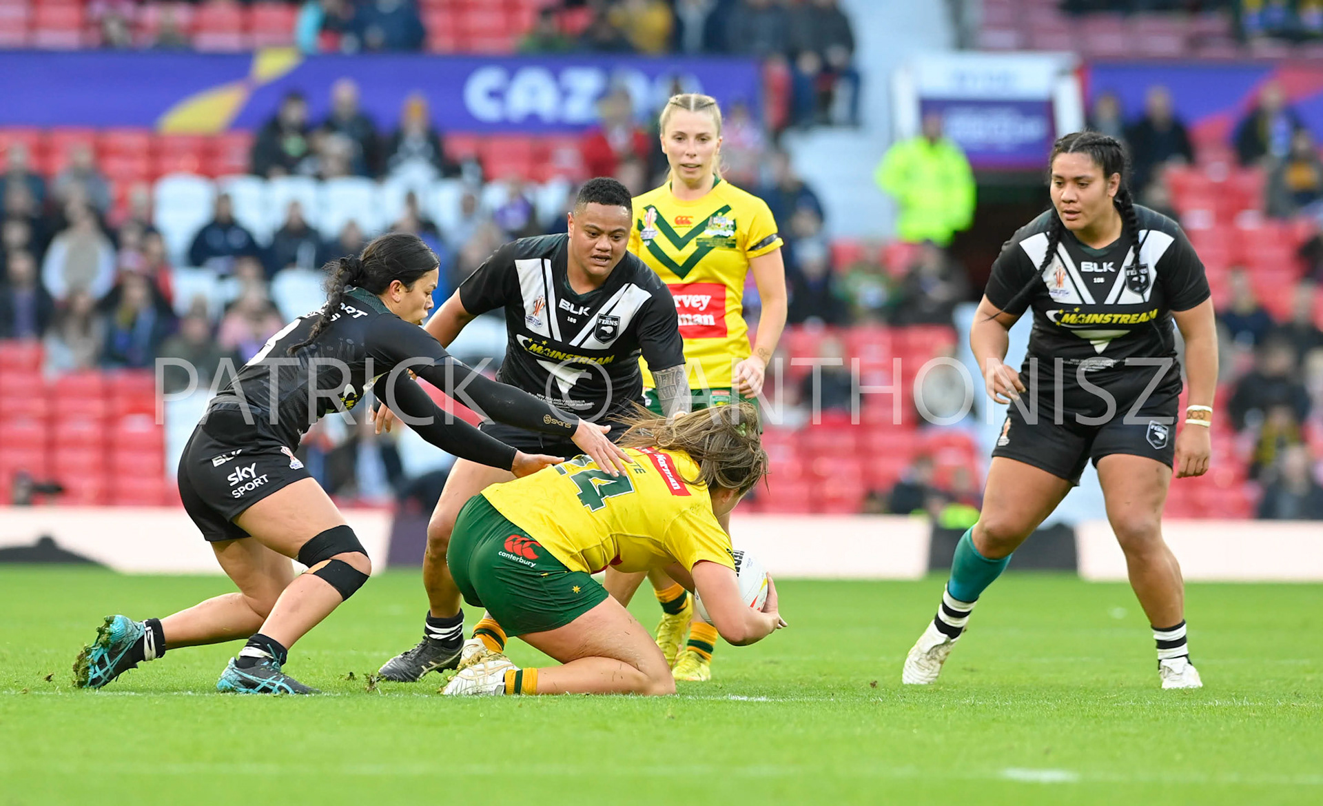Manchester   ENGLAND - NOVEMBER 19.Evania Pelite  of Australia  tries to keep hole of the ball from the  New Zealand defence during  the Rugby league World Cup Womens Final  between Australia and New Zealand  at the Old Trafford   on November 19 - 2022 in Manchester England.