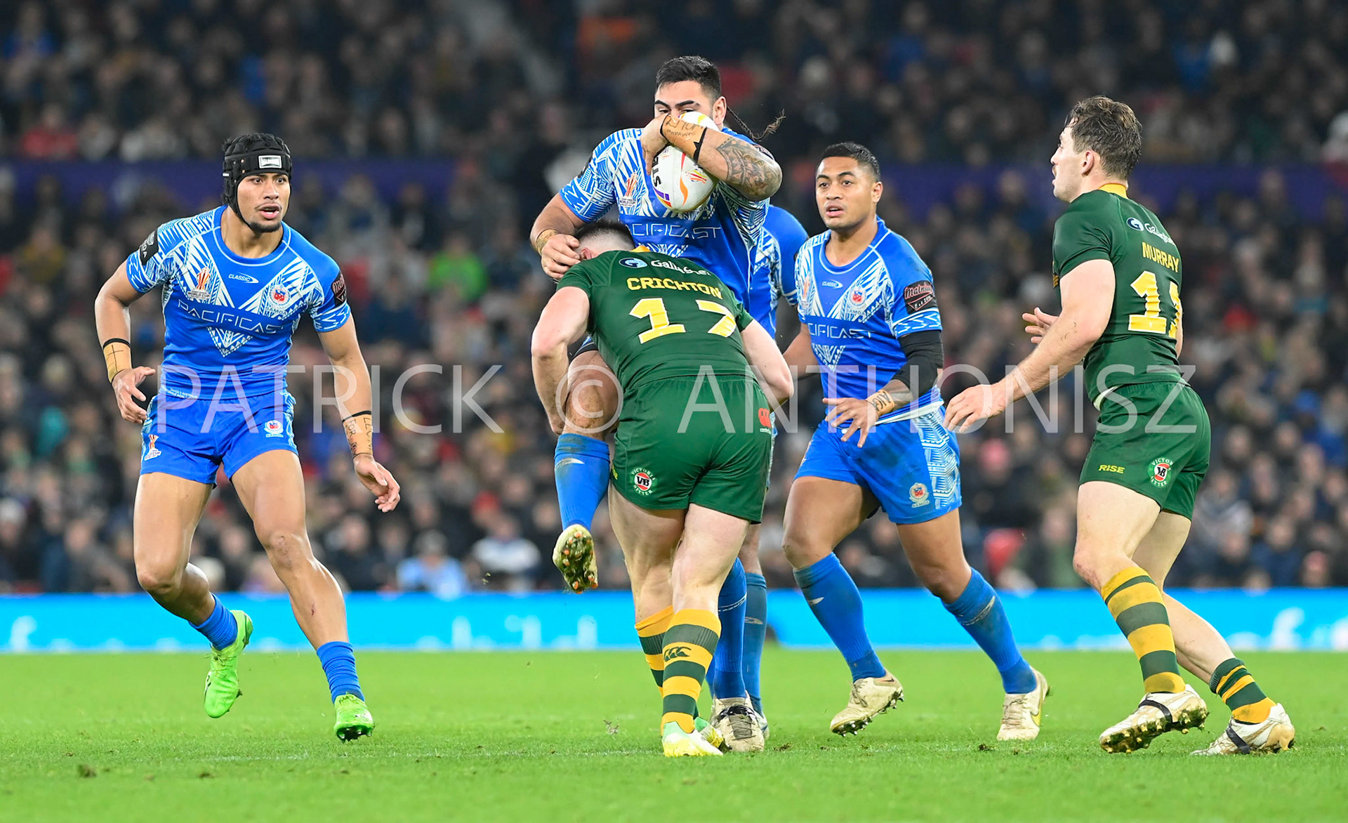 Manchester   ENGLAND - NOVEMBER 19.Angus Crichton of Australia brings down Royce Hunt of Samoa during  the Rugby league World Cup Mens Final  between Australia and Samoa at the  Old Trafford Stadium on November 19 - 2022 in Manchester England.