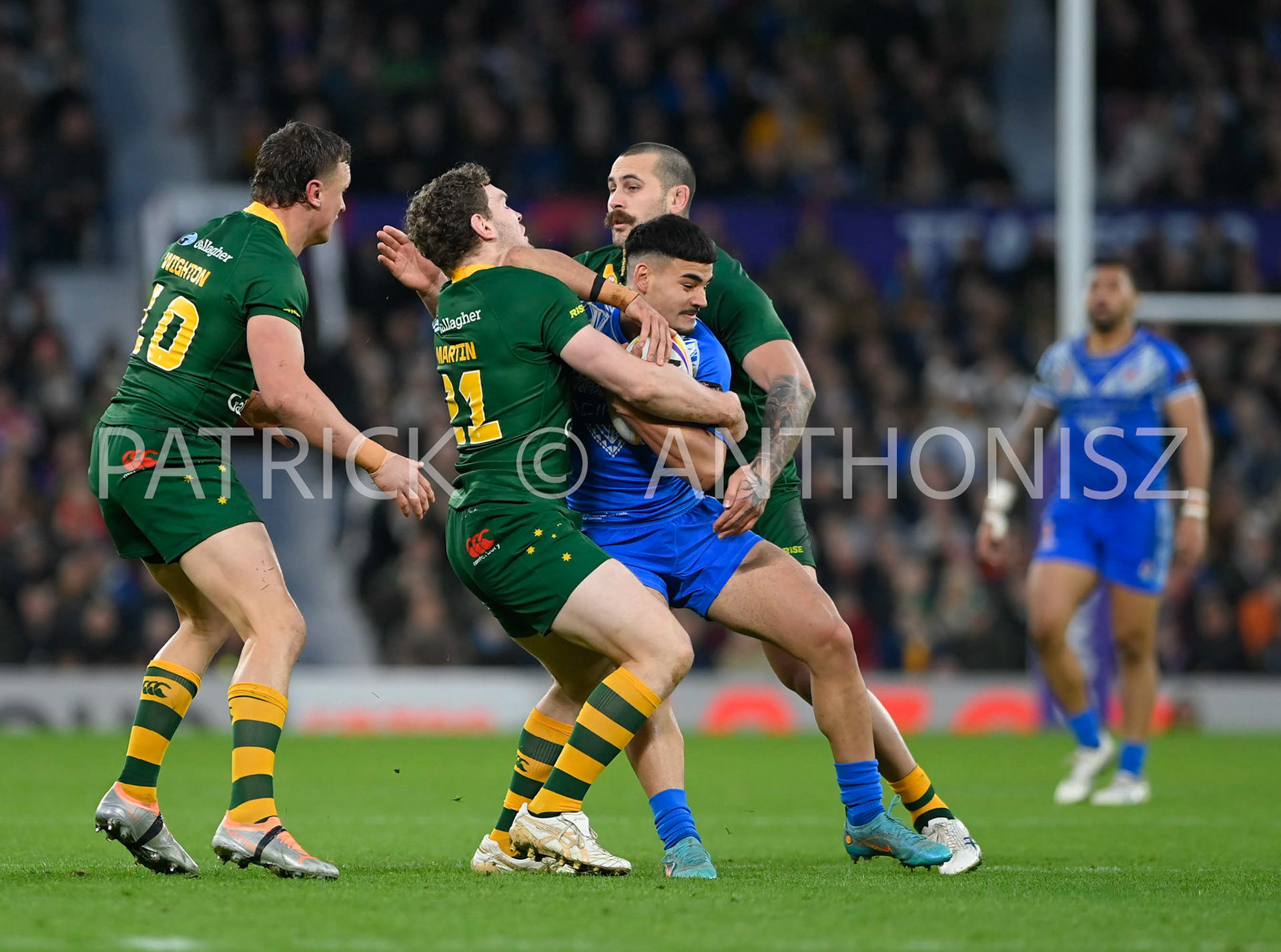 Manchester   ENGLAND - NOVEMBER 19. Taylan May of Samoa tries to breakaway from Liam Martin of Australia and  Reagan Campbell-Gillard of Australia during  the Rugby league World Cup Mens Final  between Australia and Samoa at the  Old Trafford Stadium on November 19 - 2022 in Manchester England.