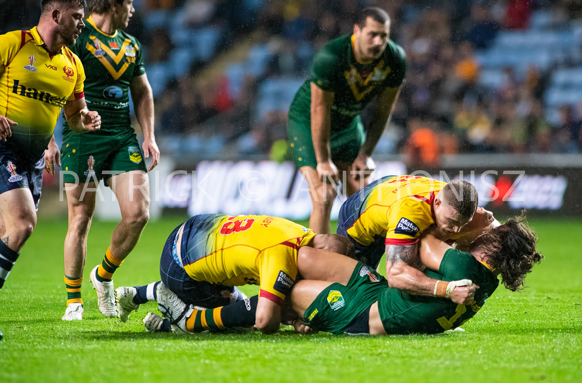Coventry England  21st October: Patrick Carrigan of Australia is held by Jack Teanby and Logan Bayliss-Brow during the Rugby League World Cup 2021 between Australia Vs Scotland  at  Coventry Building Society Arena on 21st October 2022 Australia 84: Scotland 0